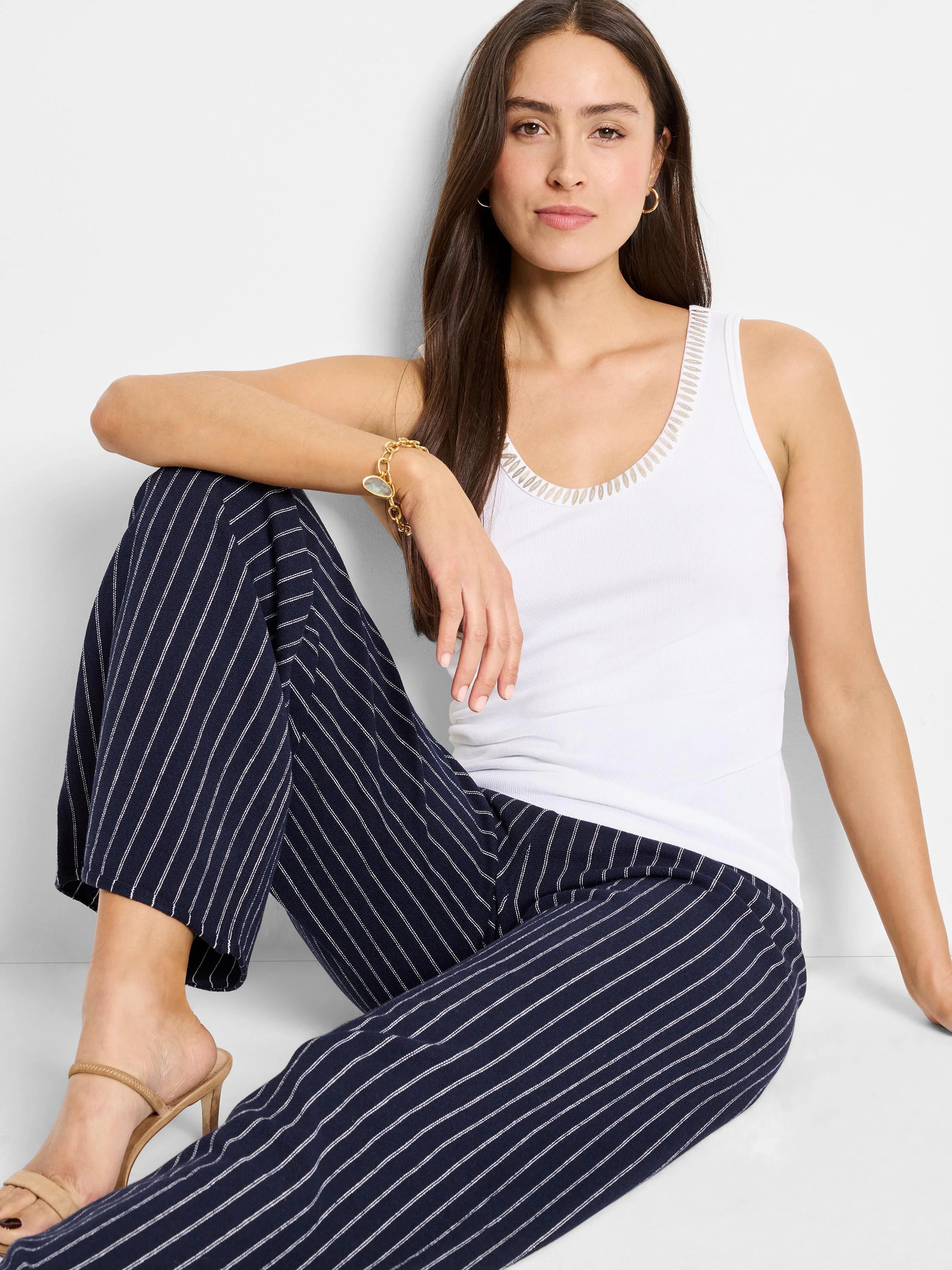 White ribbed tank top with light beige neckline trim.