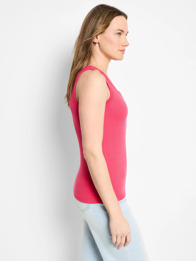 Bright pink ribbed knit scoop tank top, shown on a model from the side.