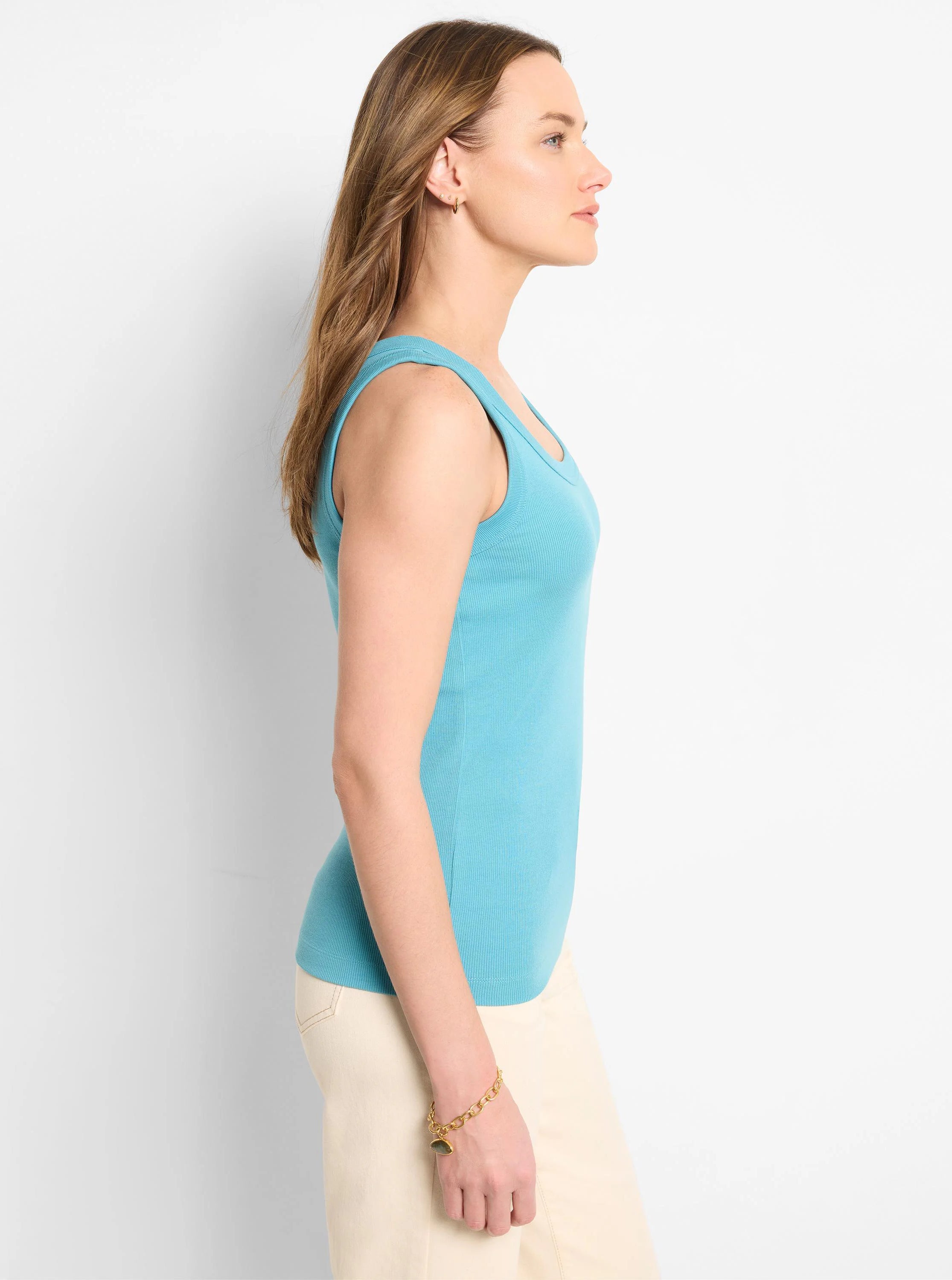 Aqua blue ribbed knit scoop tank, close-fitting on model, side view.