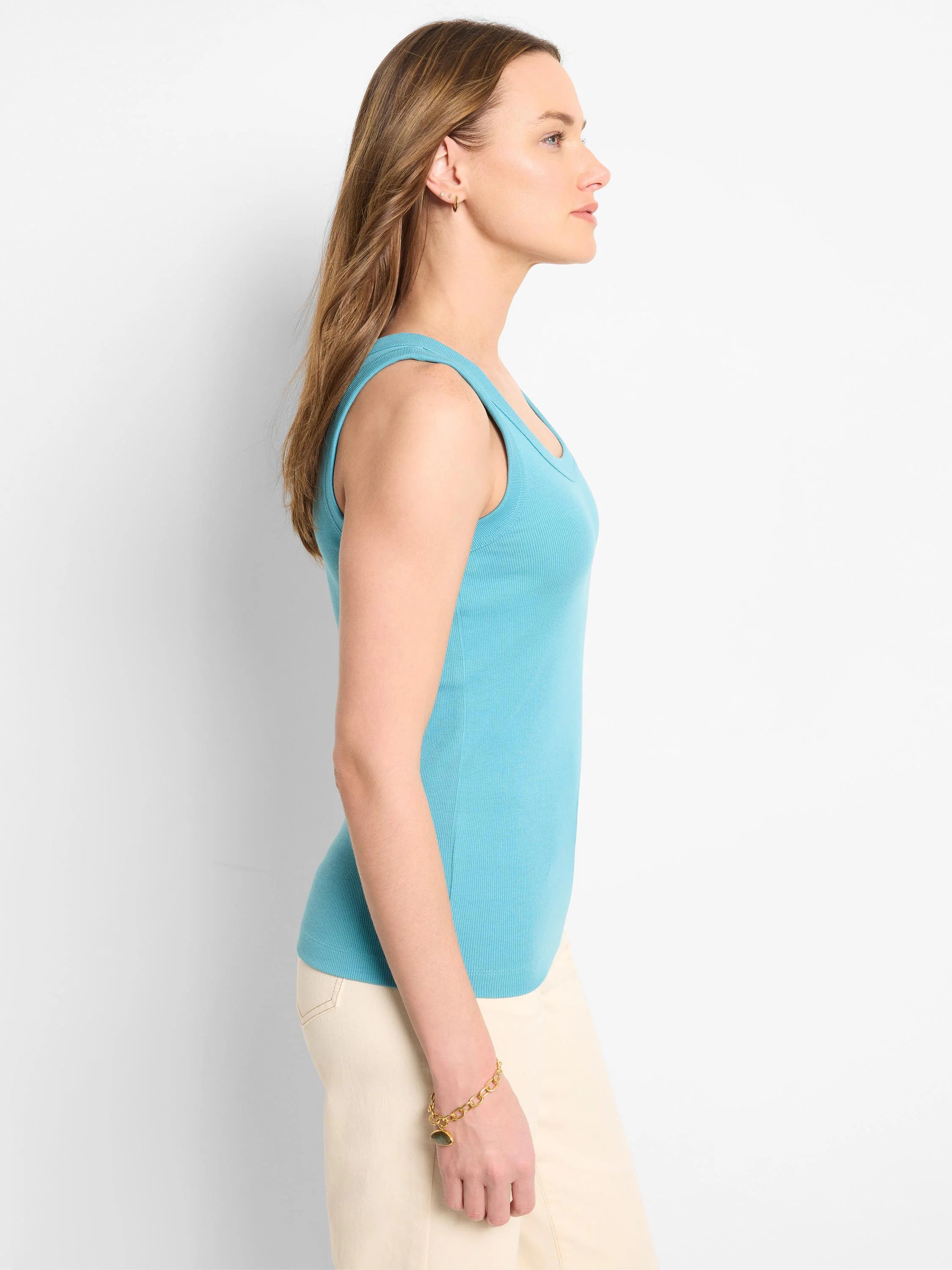 Aqua blue ribbed knit scoop tank, close-fitting on model, side view.