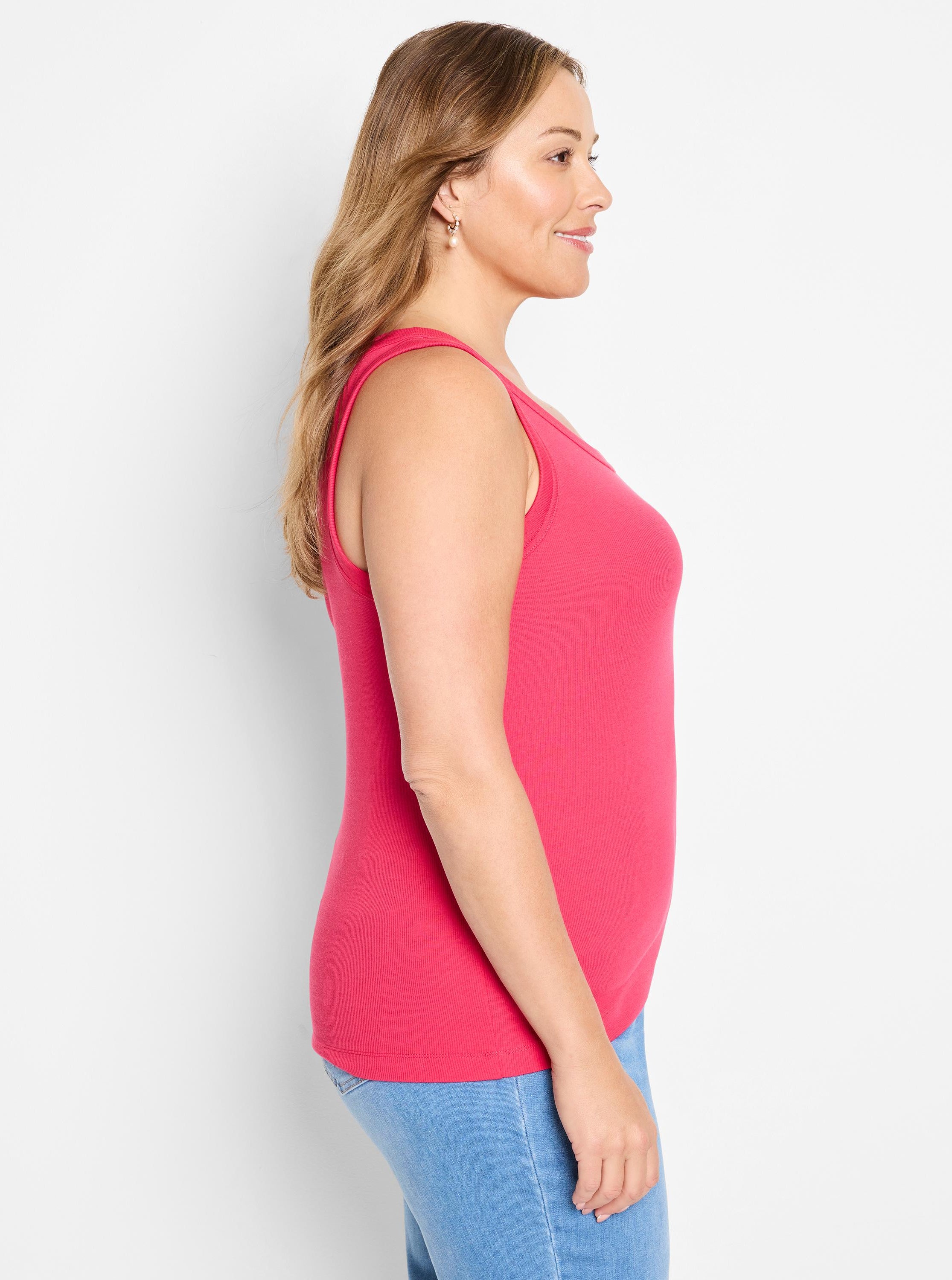 The model wears a fitted, fuchsia ribbed knit tank top with a scoop neck.