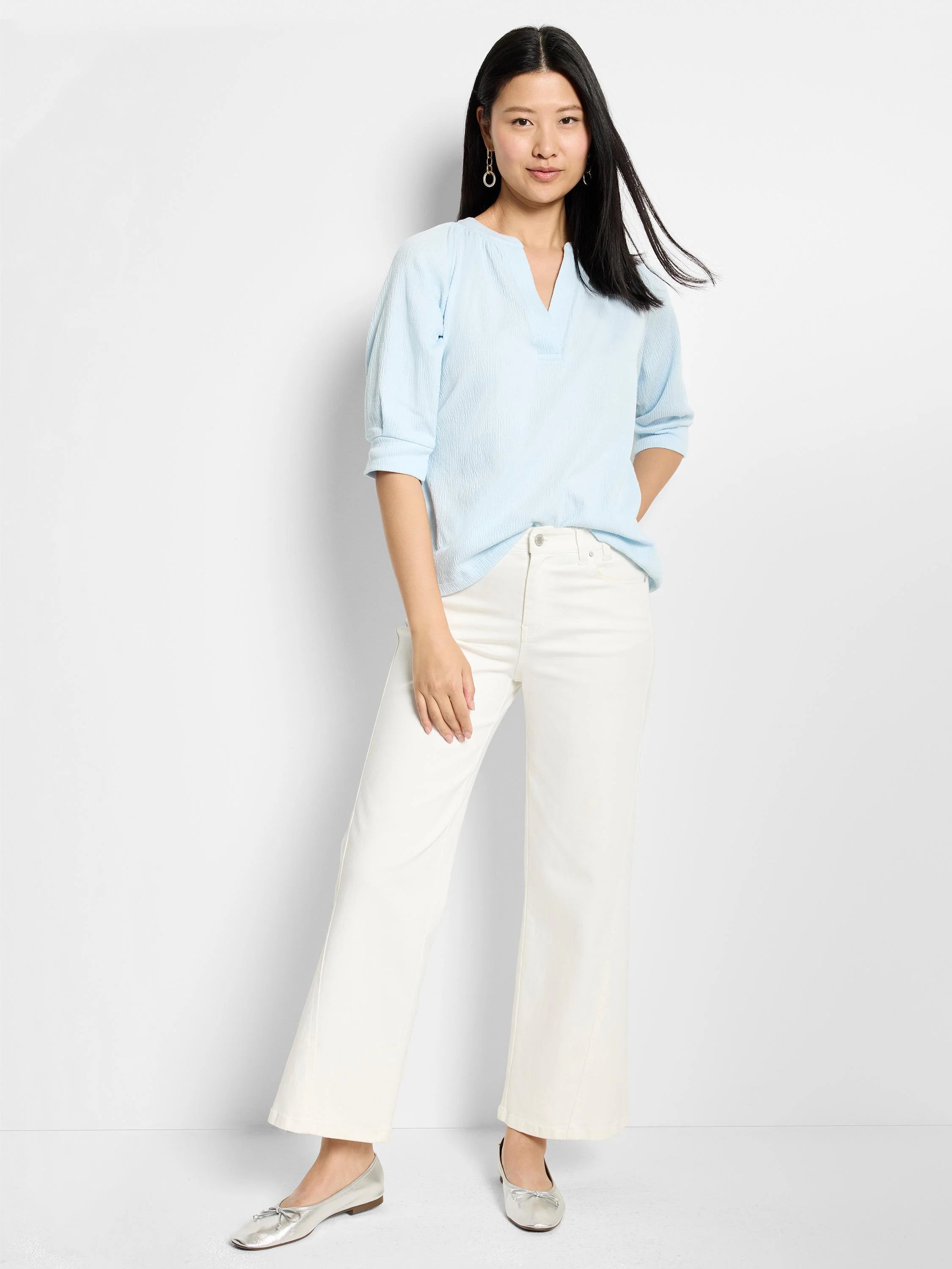Light blue, textured knit top with a V-neck and three-quarter sleeves.