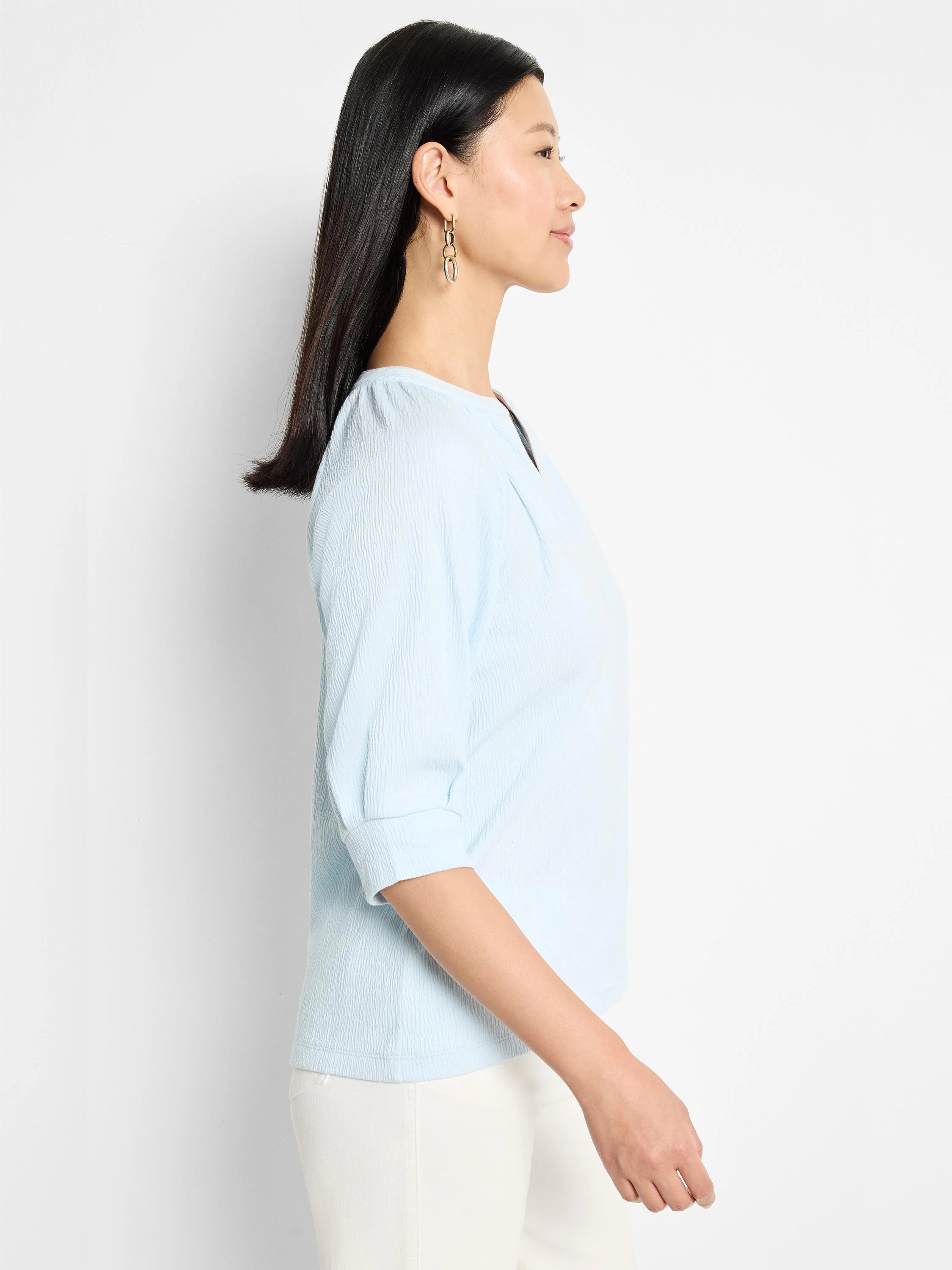 Light blue, textured knit top. Three-quarter sleeves, round neckline with keyhole detail.