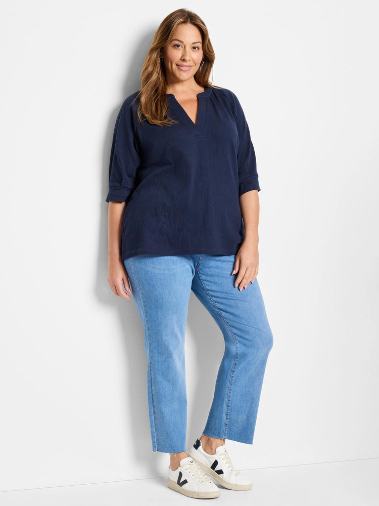 Navy blue, textured knit top with a V-neck and three-quarter sleeves.