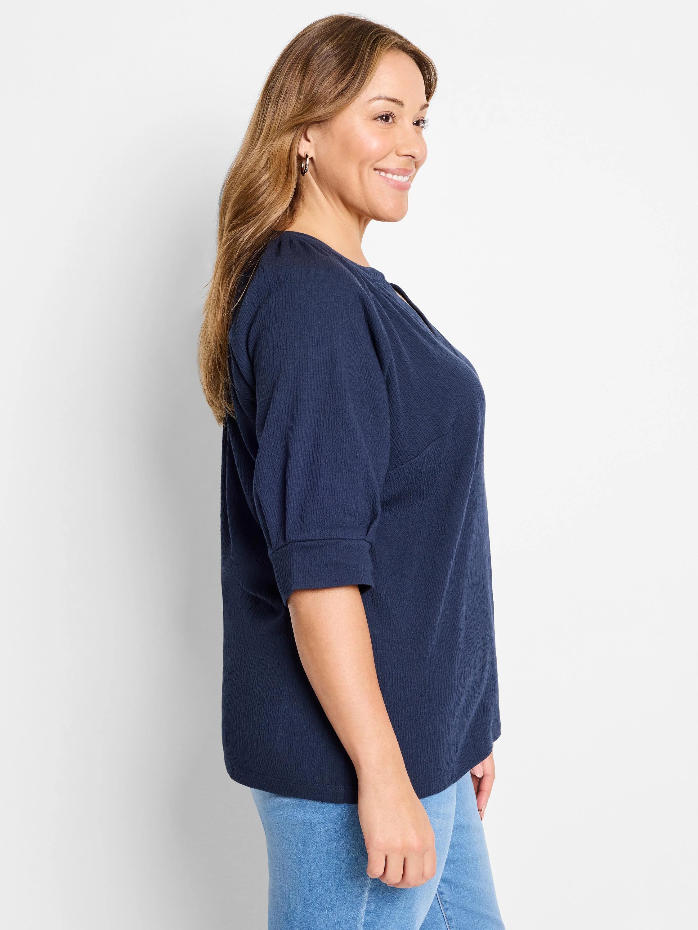 Dark navy blue, textured knit top. Three-quarter sleeves, round neckline with keyhole detail.