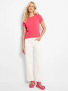 Vibrant pink knit crew neck t-shirt with short sleeves.