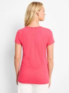 Pink knit crew neck t-shirt with short sleeves, modeled from the back.