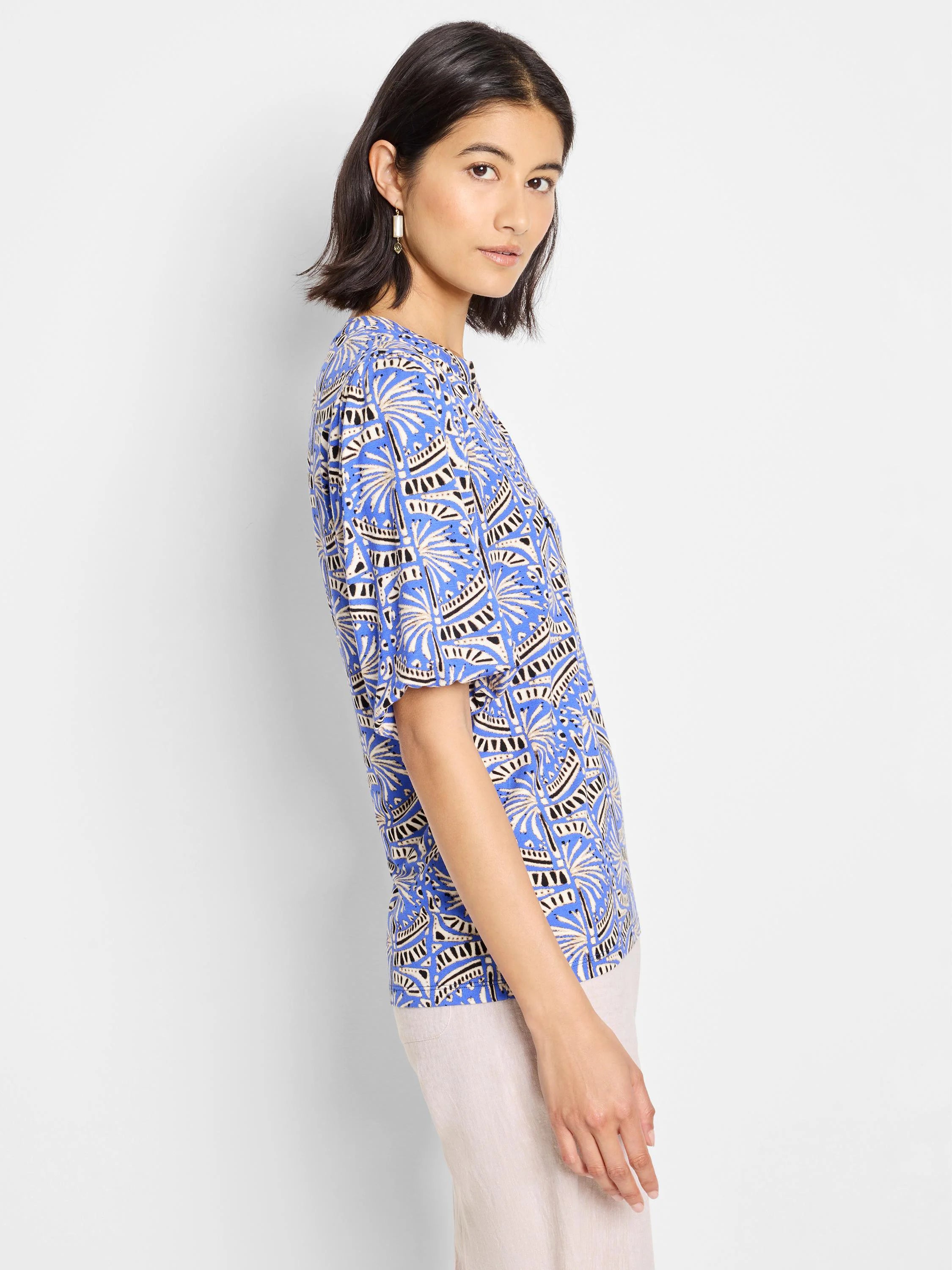 Blue top with short sleeves, featuring a beige and black geometric print.
