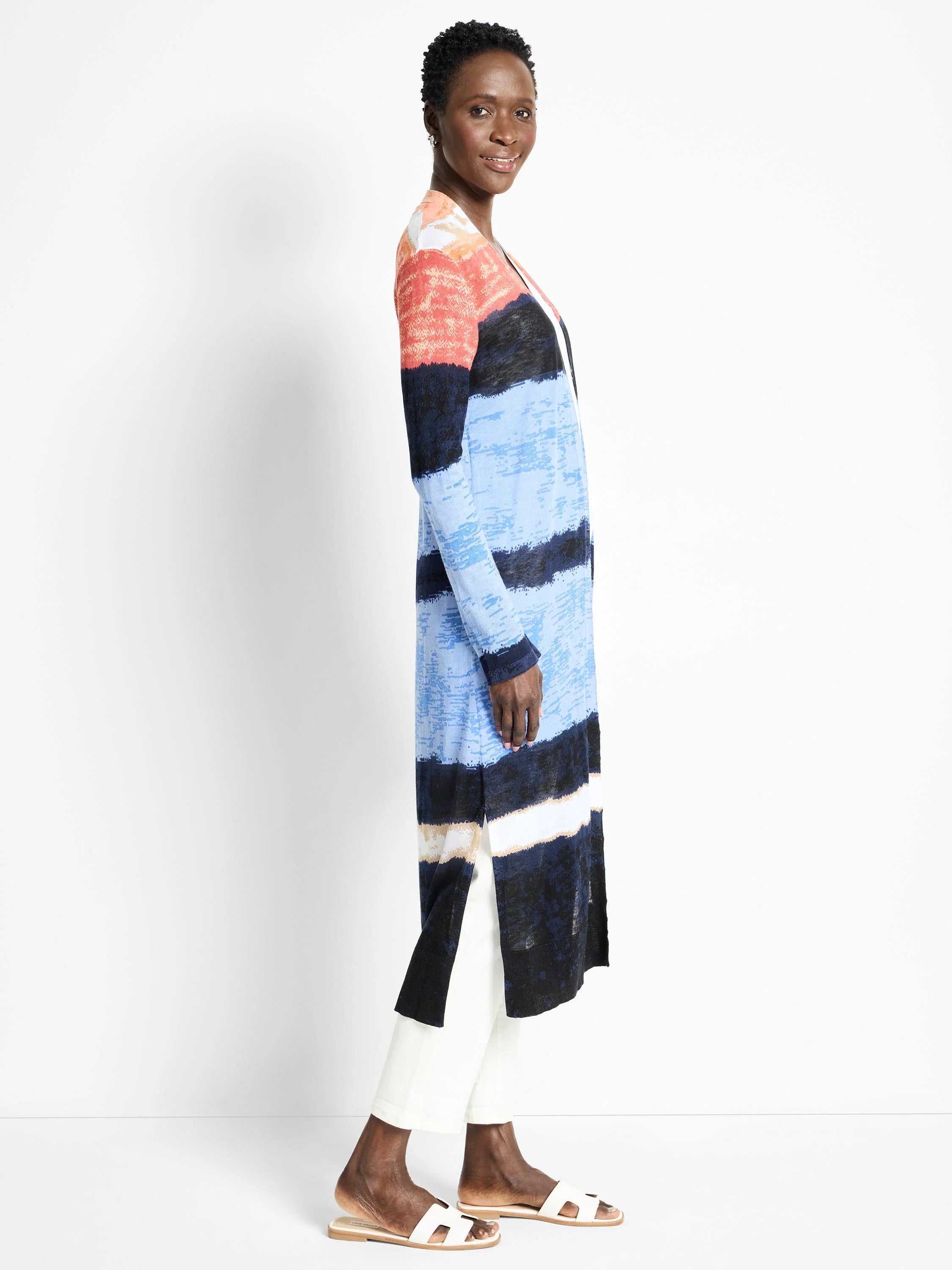 Long, horizontal-striped cardigan in coral, light blue, navy, and beige. Open front, long sleeves.