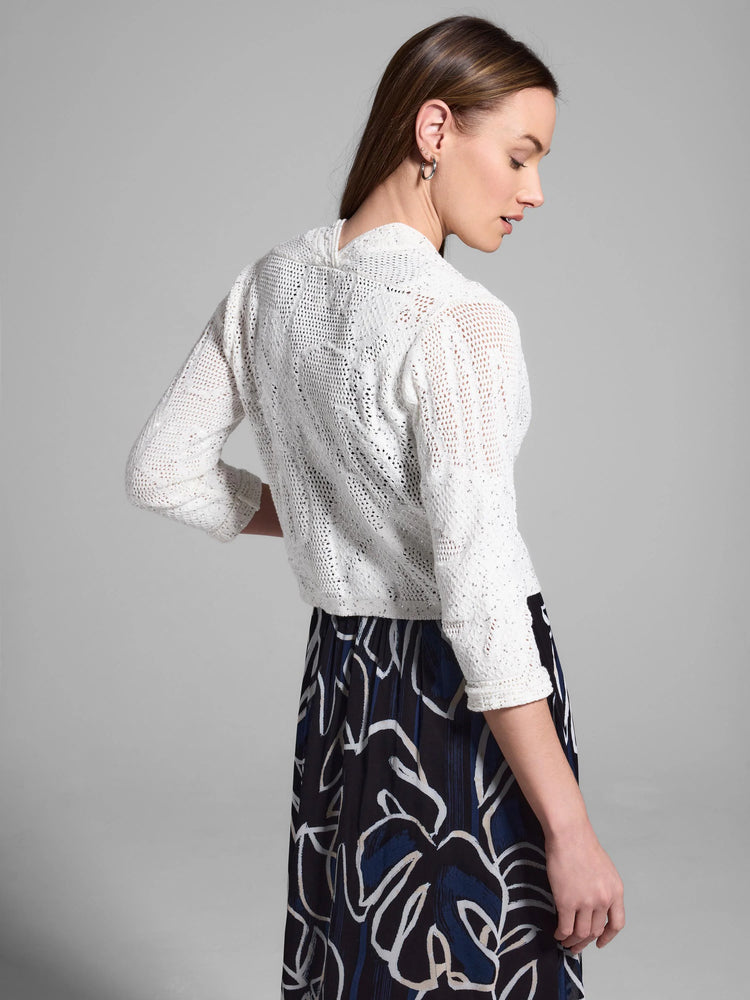 Off-white, open-knit cardigan with subtle sequins. Three-quarter sleeves.