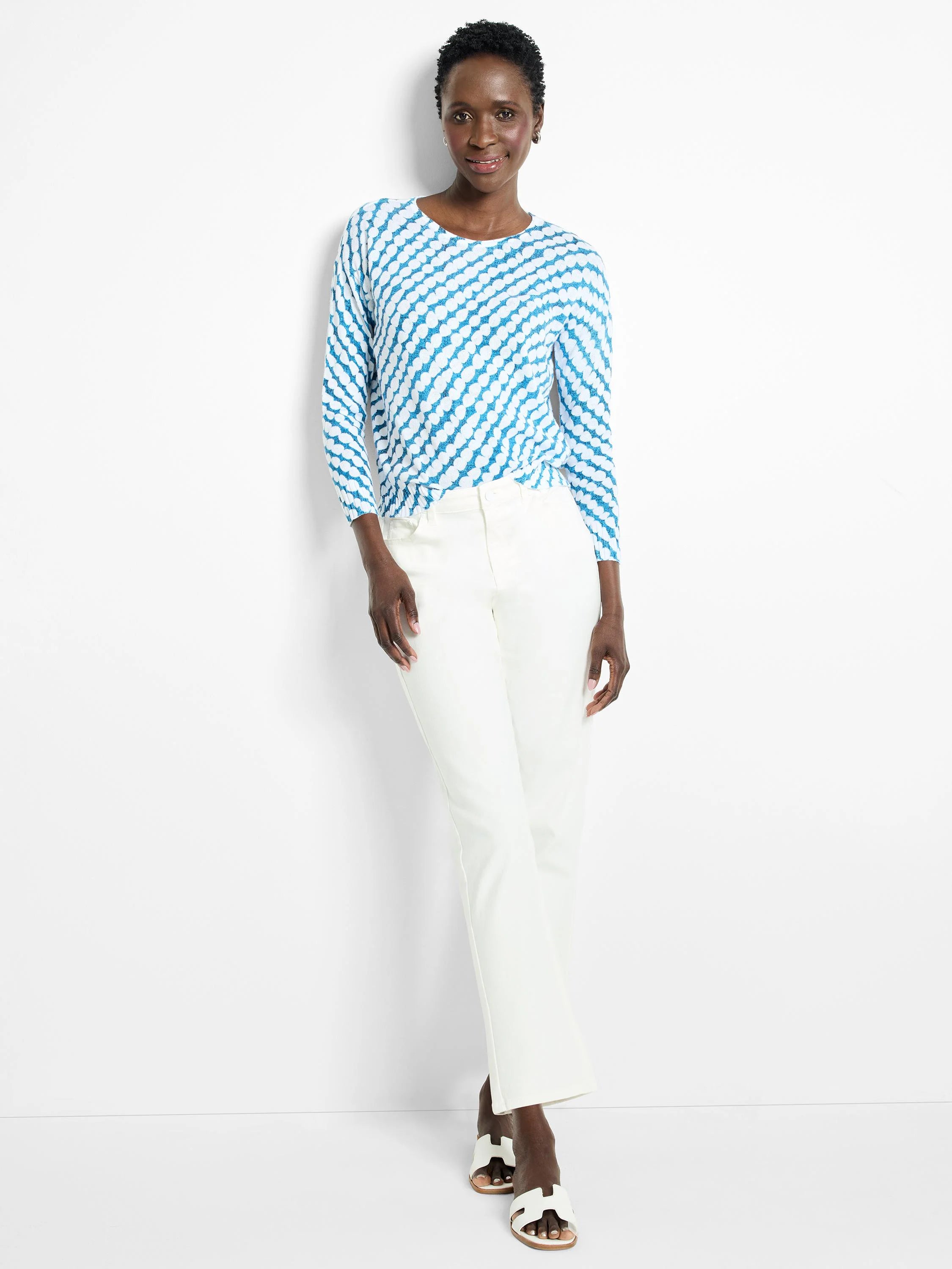 Blue and white patterned, long-sleeved sweater. The pattern is a swirling design.