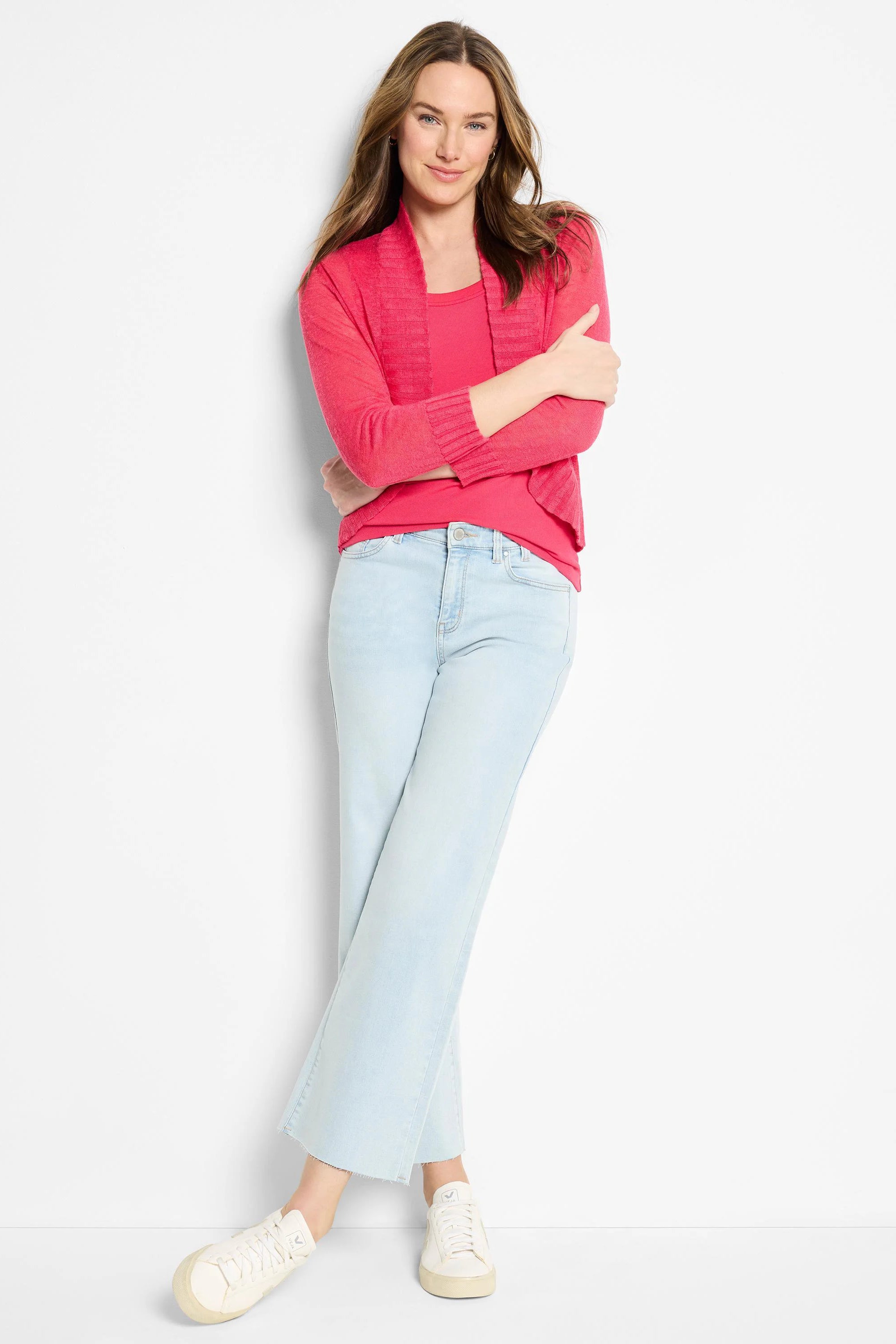 Fuchsia pink bolero cardigan, open front, waist-length, long sleeves, ribbed cuffs, and textured knit.