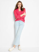 Fuchsia pink bolero cardigan, open front, waist-length, long sleeves, ribbed cuffs, and textured knit.