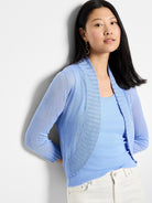Light blue bolero cardigan. Features an open front, ribbed shawl collar, and long sheer knit sleeves.