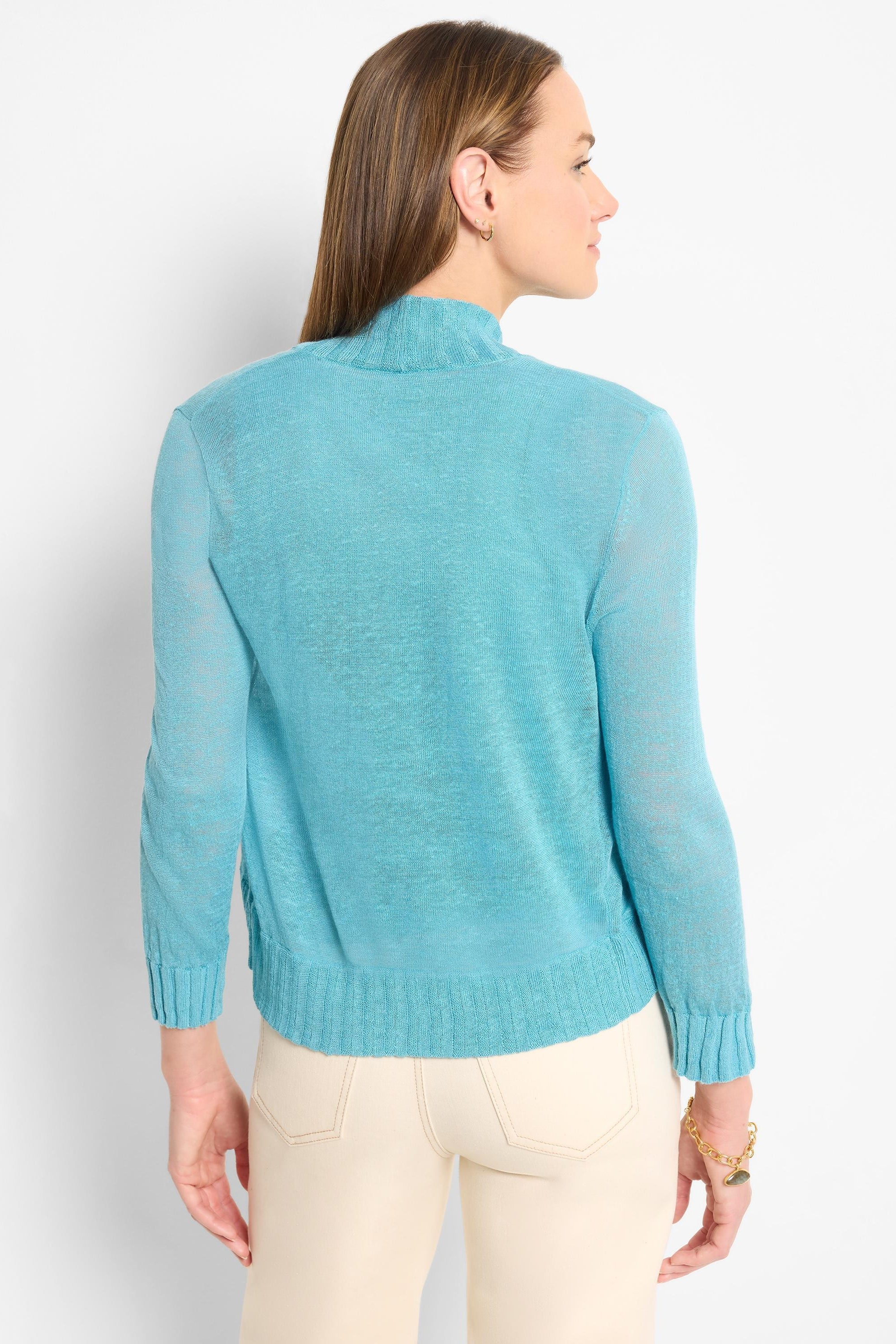 Bright blue bolero cardigan with mock neck, long sleeves, and a fine, lightweight knit. Ribbed cuffs and hem.
