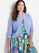 Periwinkle blue bolero cardigan with ribbed open front, 3/4 sleeves, and fine knit texture.