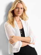 White mesh cocoon cardigan with an open front, loose draped fit, and visible open-knit texture.
