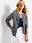 Navy and off-white mixed-weave knit jacket. Features herringbone pattern on body, collarless neckline, zipper front, and...