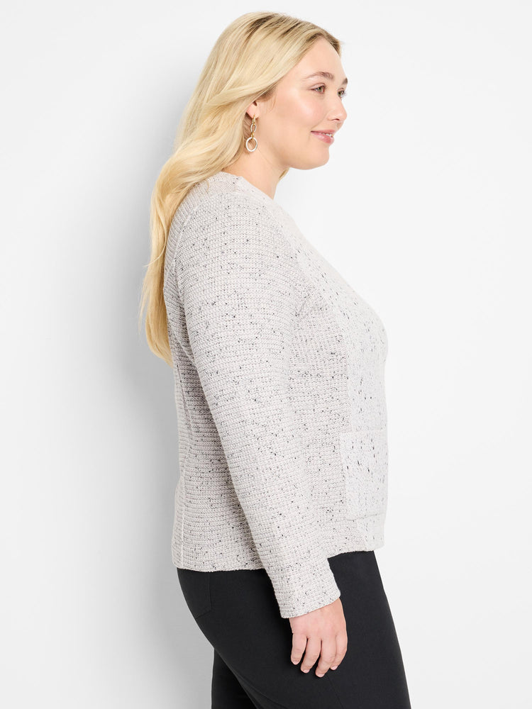 Model wears a fitted light gray speckled crew neck sweater.