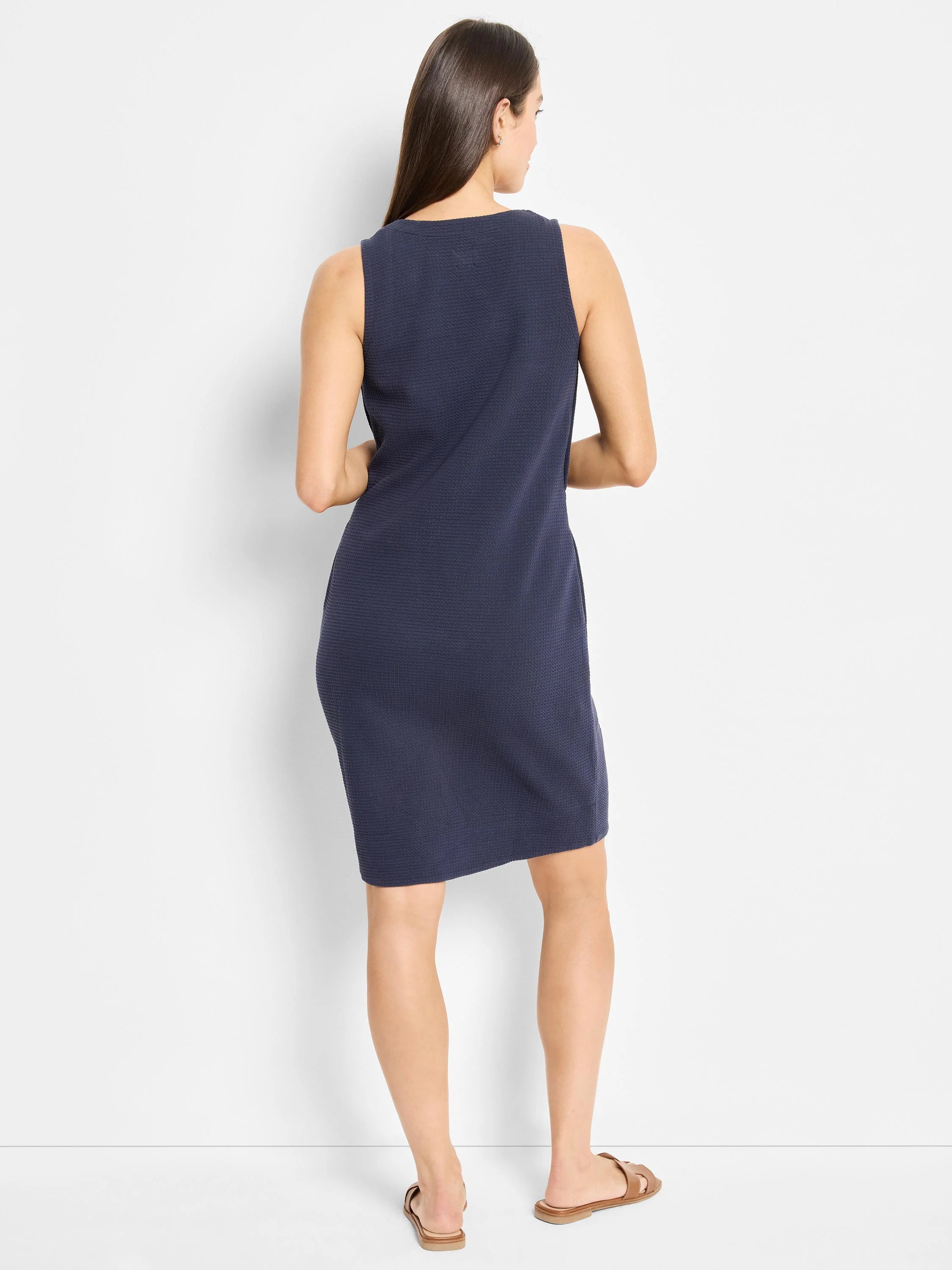 Dark navy blue, sleeveless, textured knit mini dress. Straight silhouette.