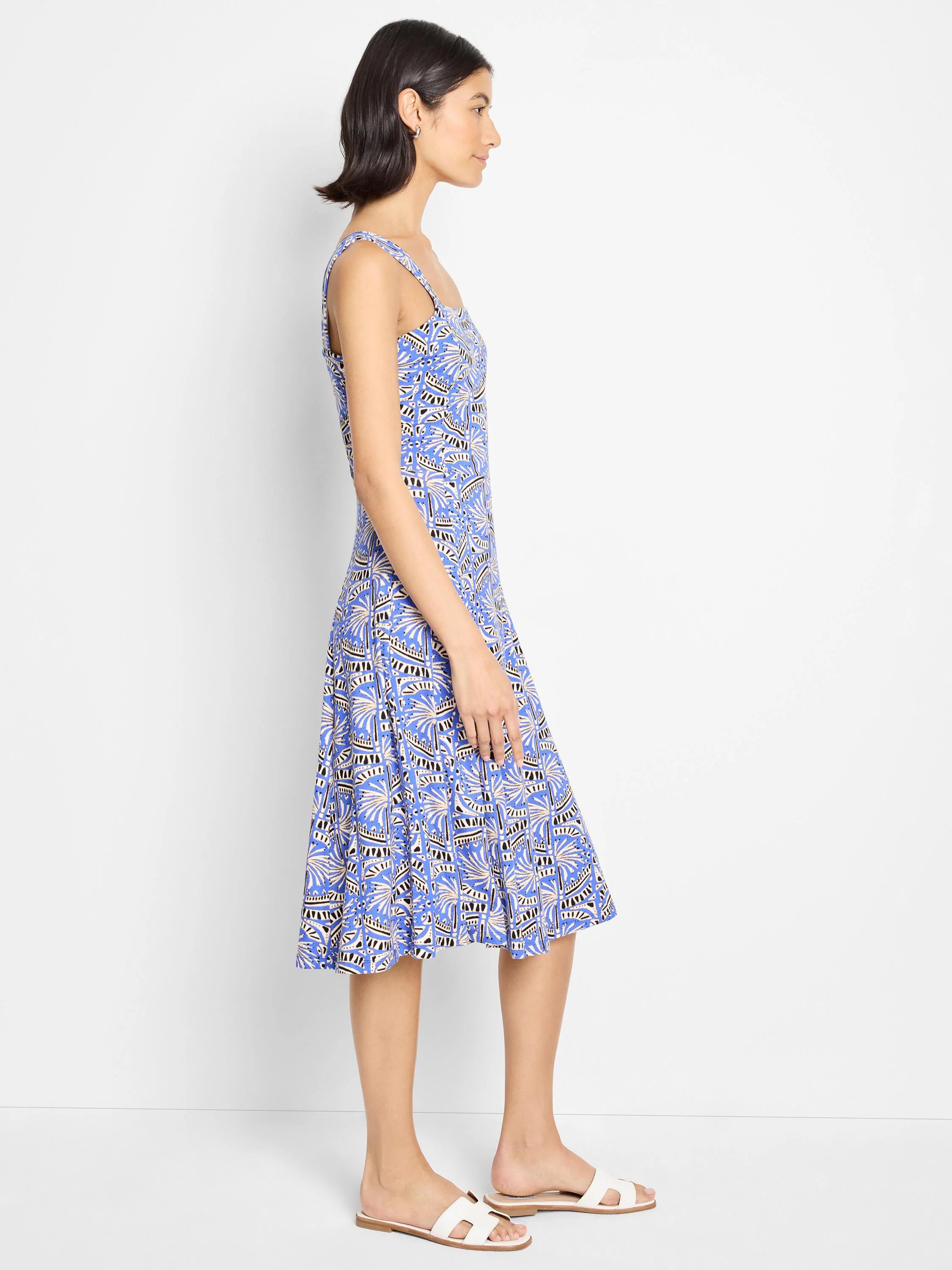 Blue midi dress with a white and black geometric print. Sleeveless, A-line silhouette.