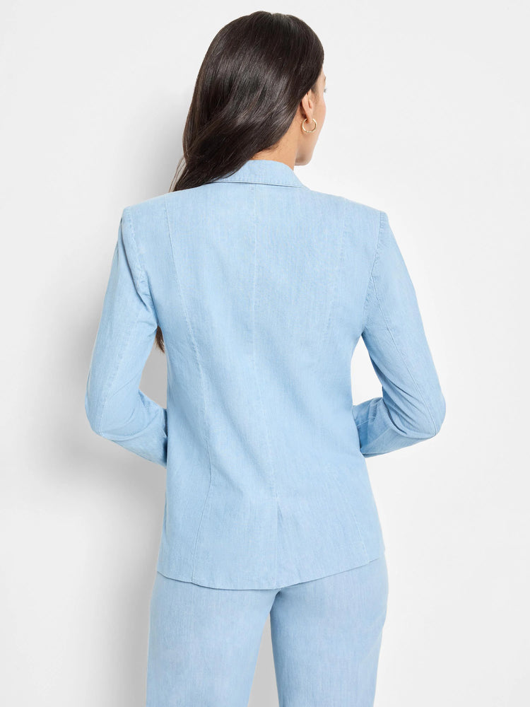 Light blue denim blazer, long sleeves, collared. Seen from the back.