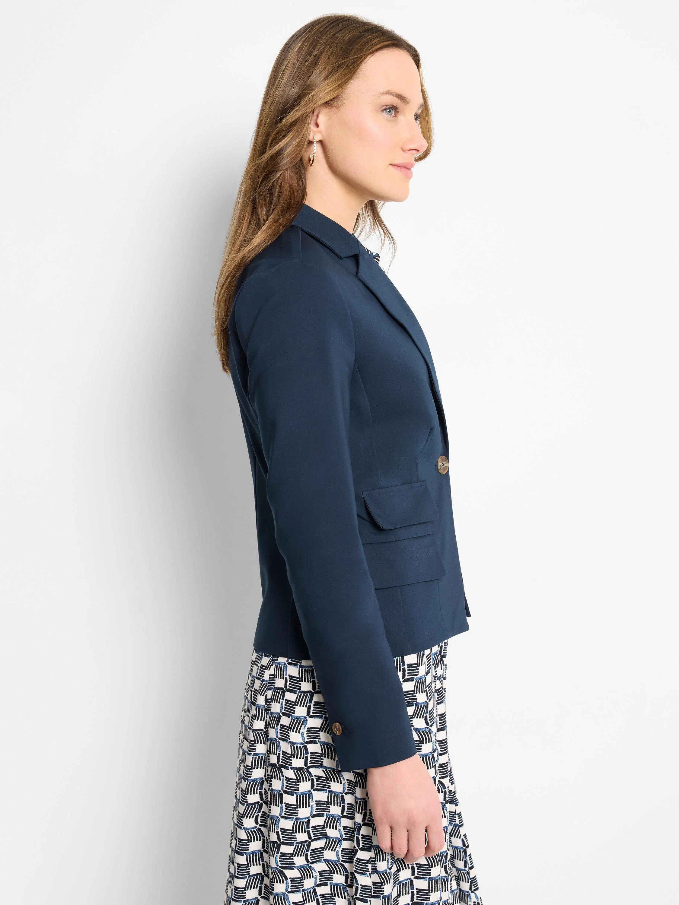 Navy blue blazer, single button, two pockets.  Model shown wearing it with a black and white patterned dress.