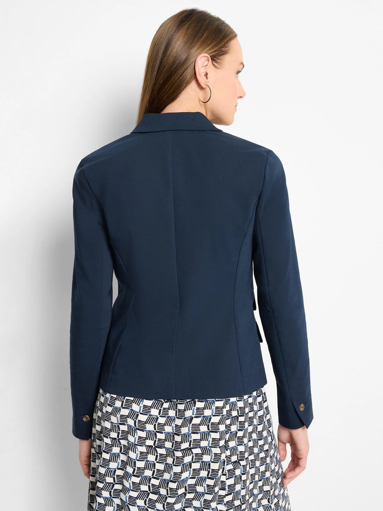 Dark navy blue blazer, double-breasted, long sleeves with buttons. Back view.