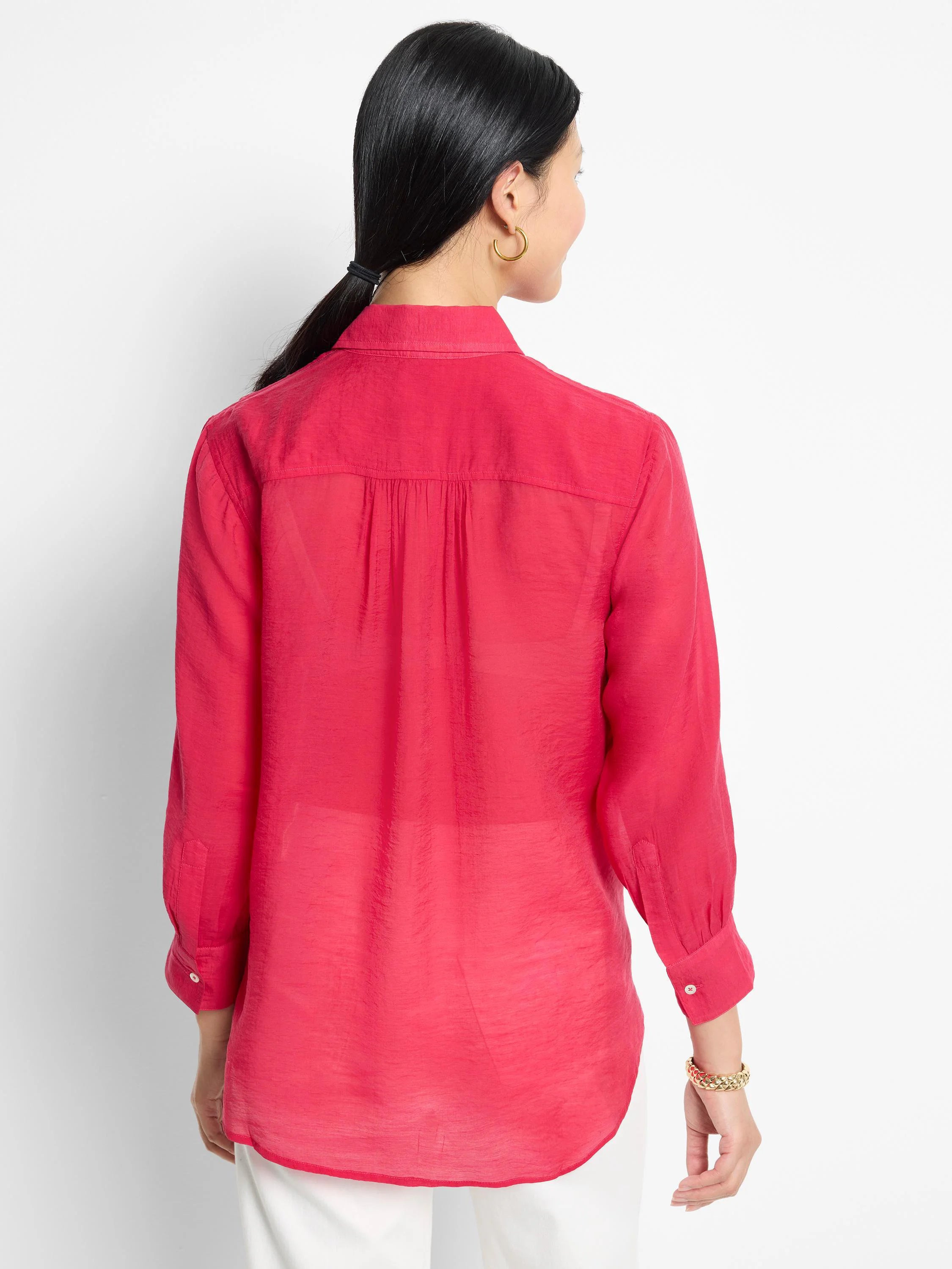 Back view of a bright pink, collared, long-sleeve shirt. Slightly sheer fabric with subtle texture.