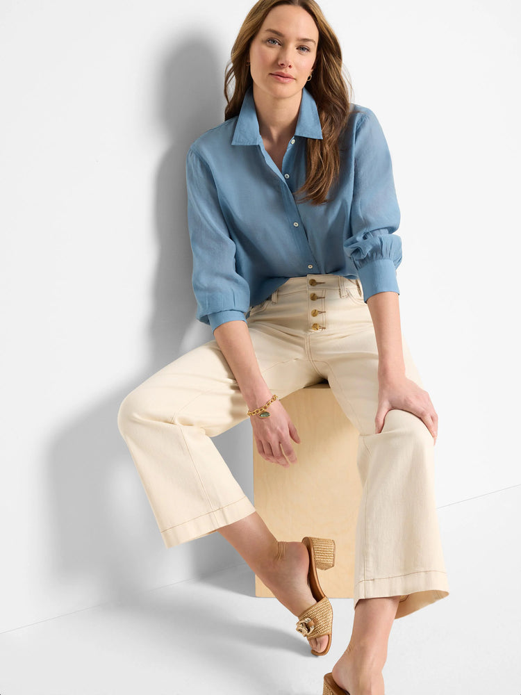 Dusty blue, long-sleeve collared shirt. Relaxed fit, slightly puffed sleeves.