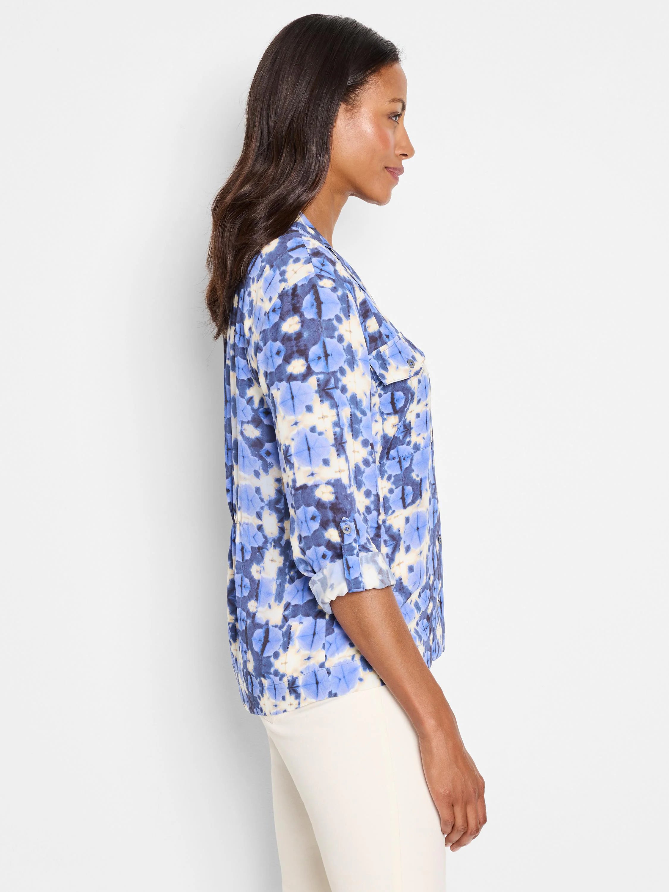 Shibori-print shirt; blue, beige, and dark-blue pattern. Three-quarter sleeves, buttoned cuffs, and chest pockets.