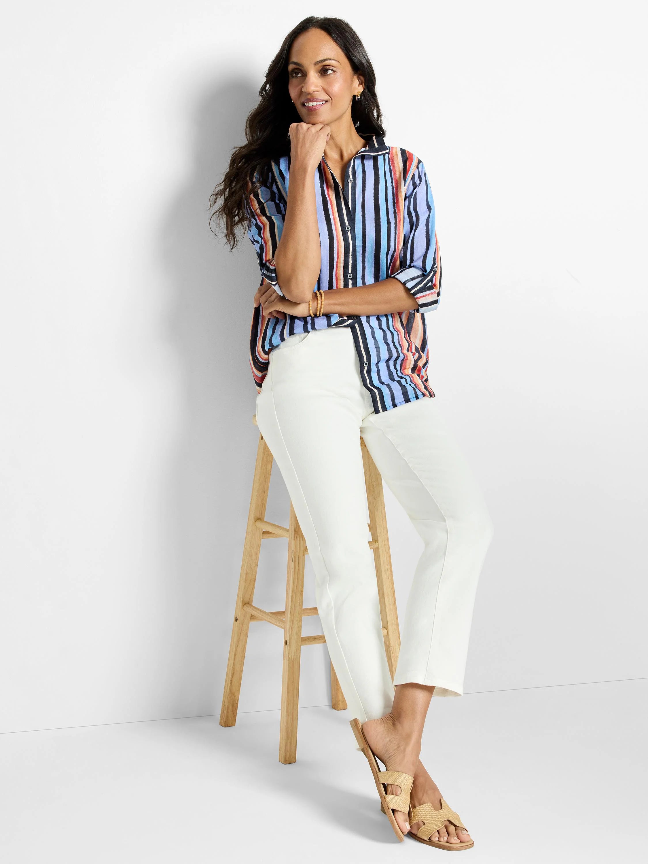 Cotton shirt with vertical stripes in blue, black, orange, and red on a white background. Three-quarter sleeves.