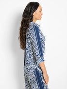 Blue and white patterned shirt;  geometric design with vertical stripes.  Three-quarter sleeves, collared.