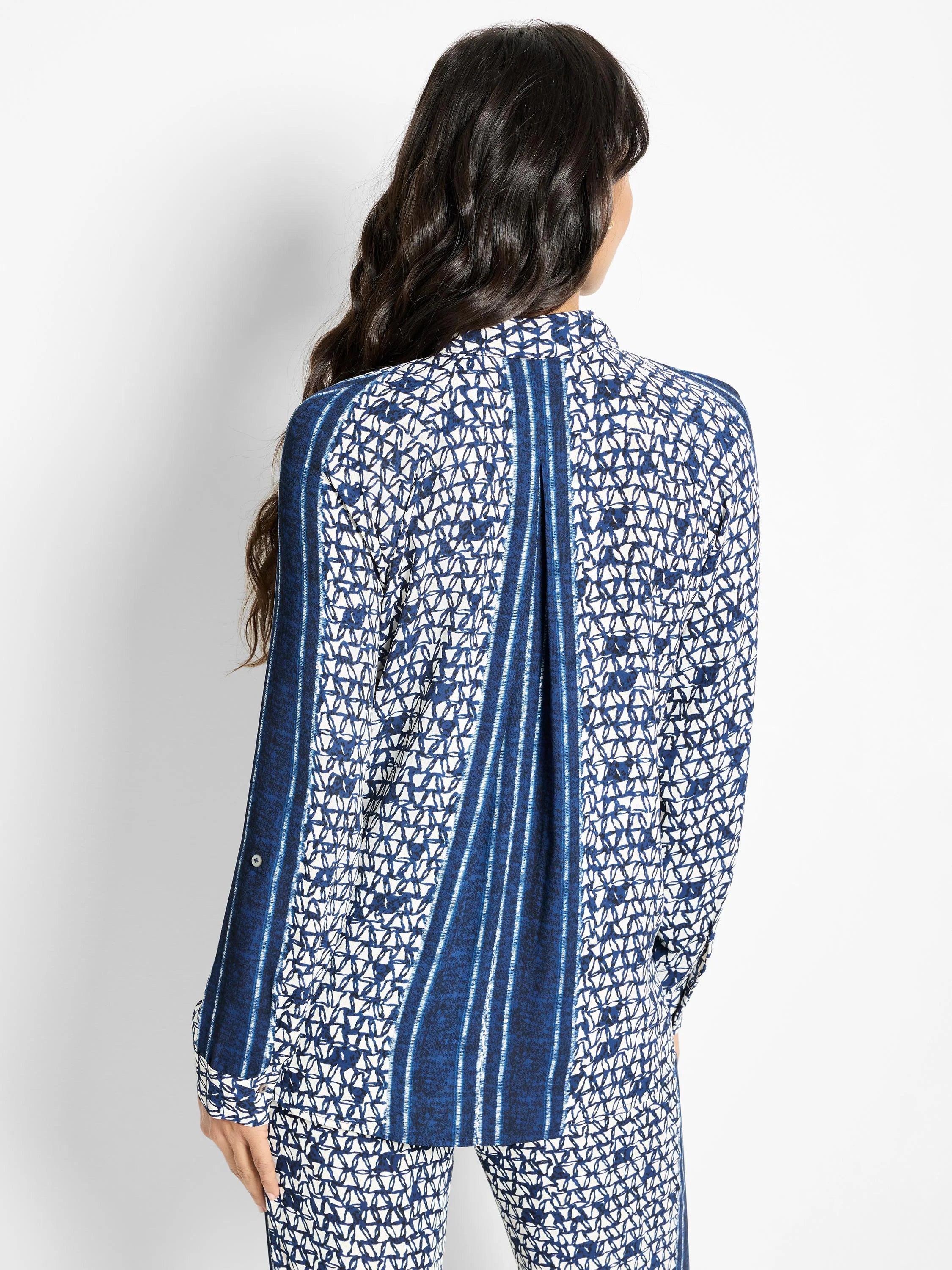 Blue and white patterned long-sleeve shirt; geometric print with vertical stripes.