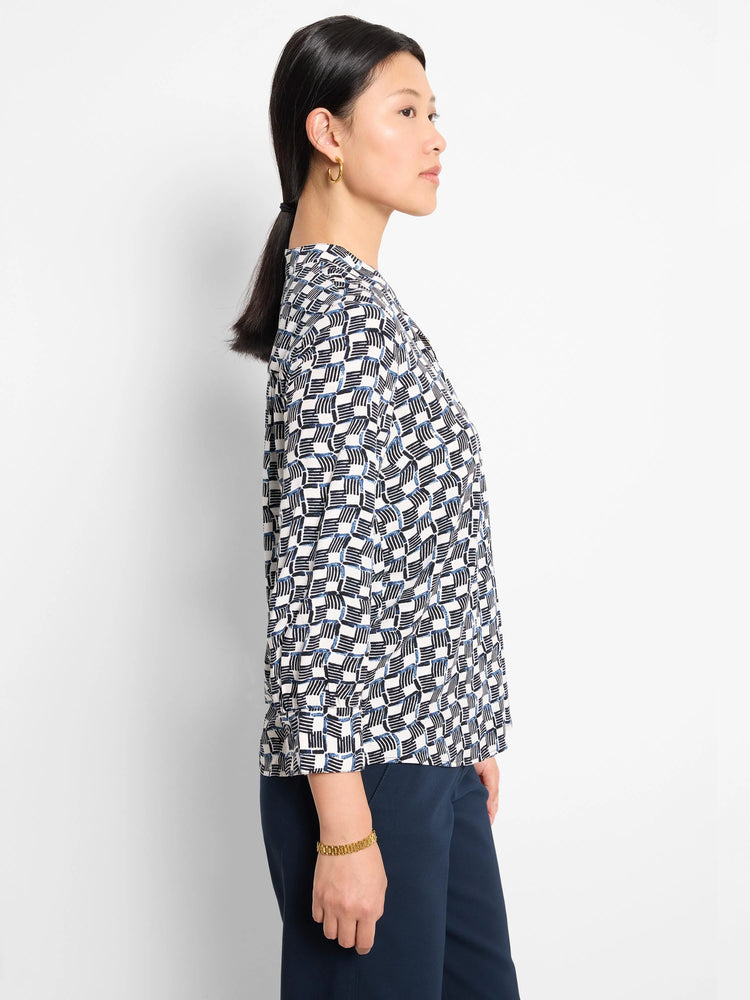 Off-white shirt with a geometric pattern in navy and black. Three-quarter sleeves.
