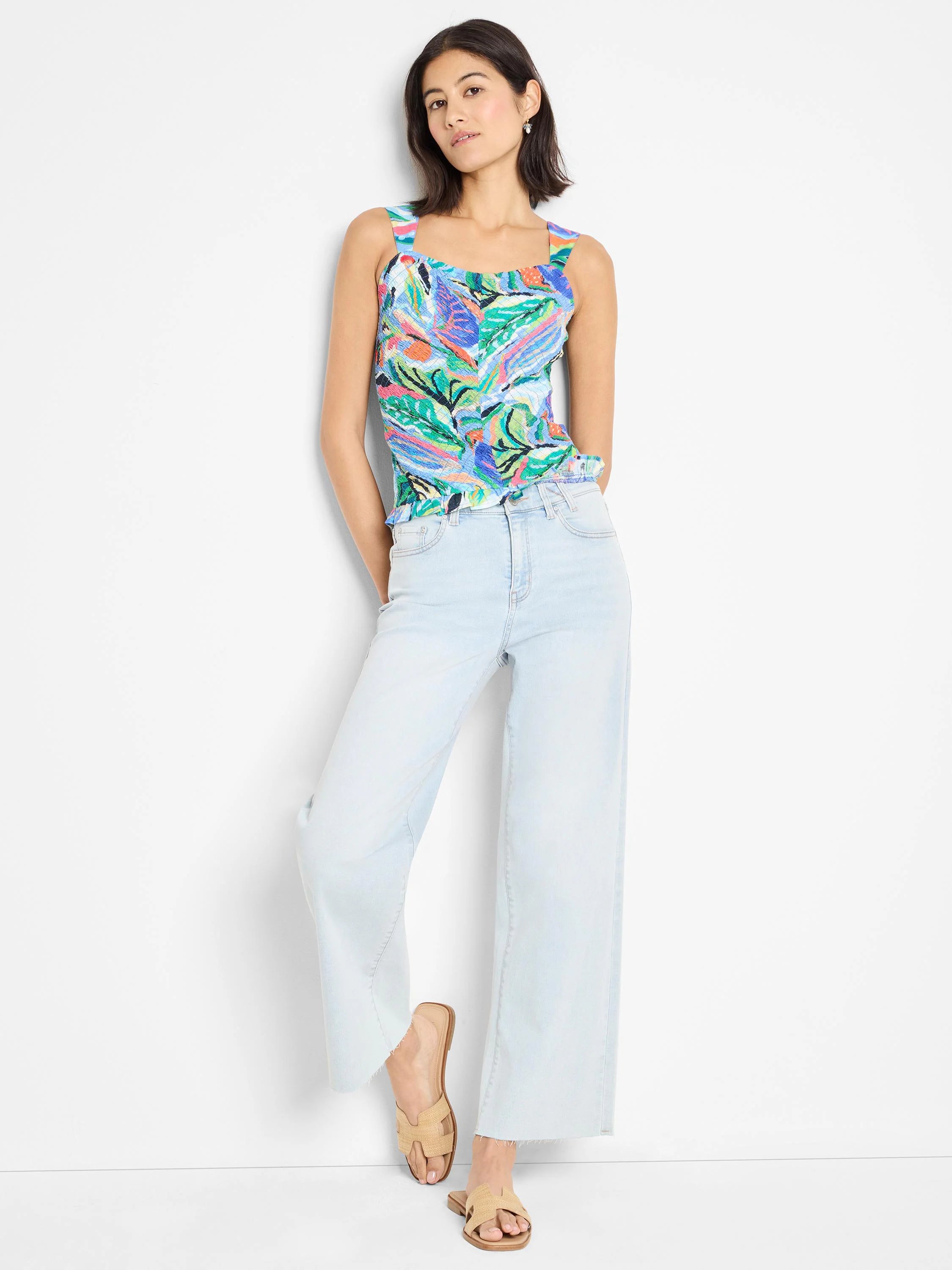 Smocked tank top with abstract blue, green, orange, and pink pattern. Square neckline, sleeveless.