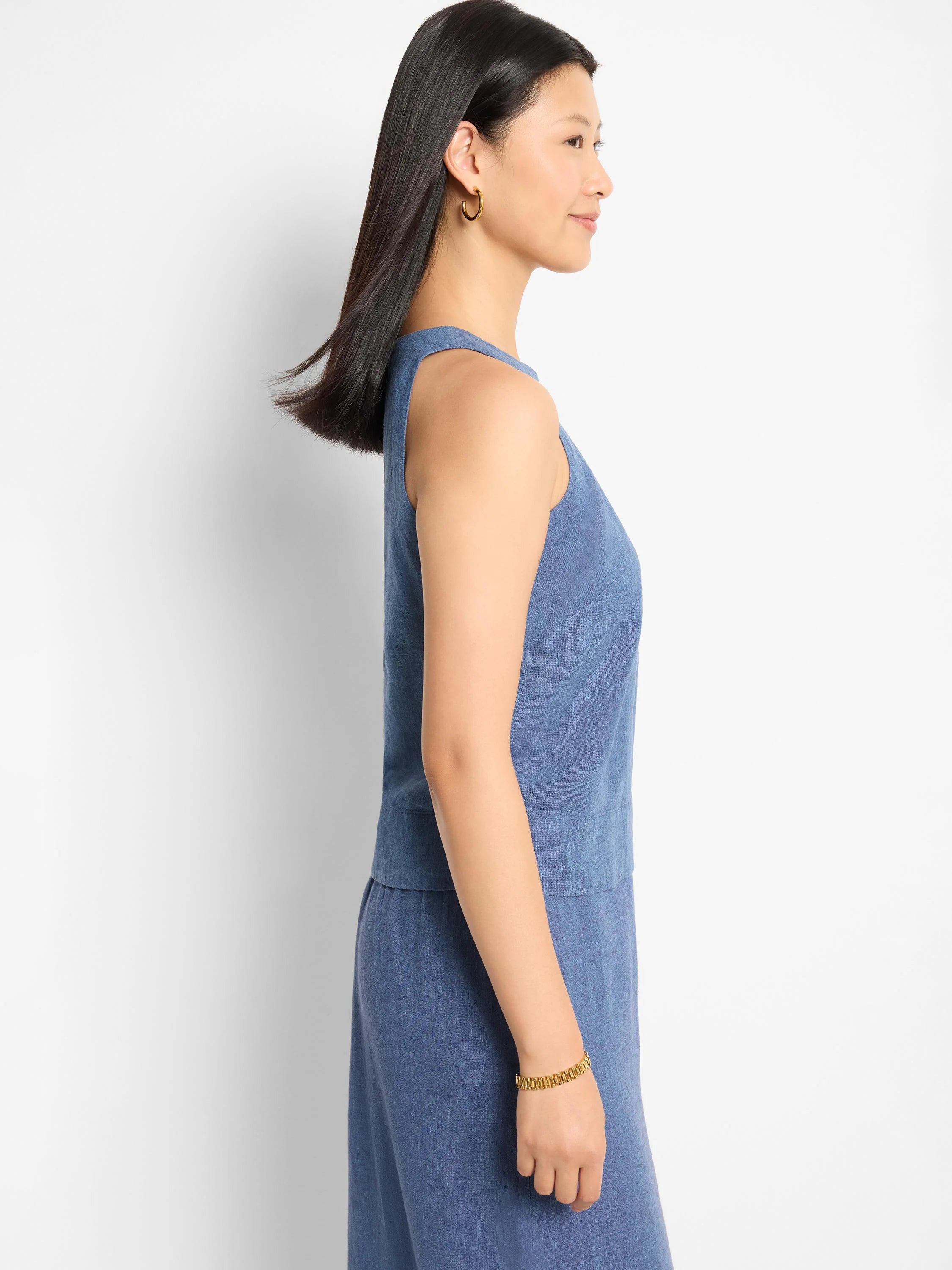Blue linen sleeveless top, shown in profile view. Slightly loose fit.