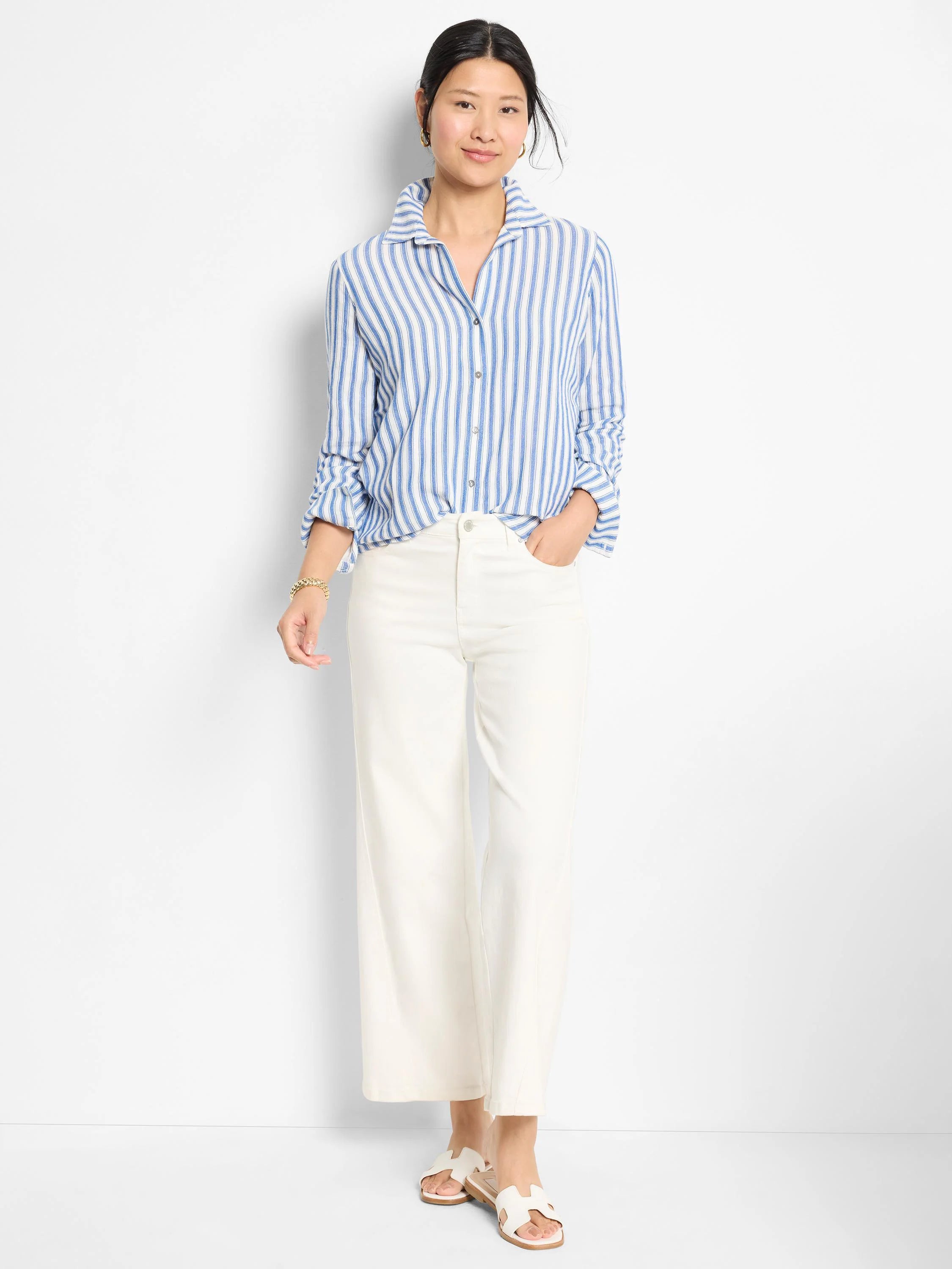 Blue and white vertical striped, long-sleeved button-down shirt.