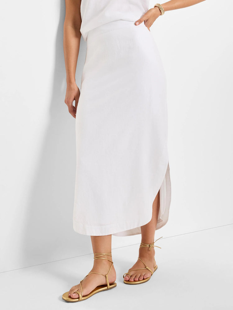 White linen midi skirt with a high waist and asymmetrical hem. Side slit detail.