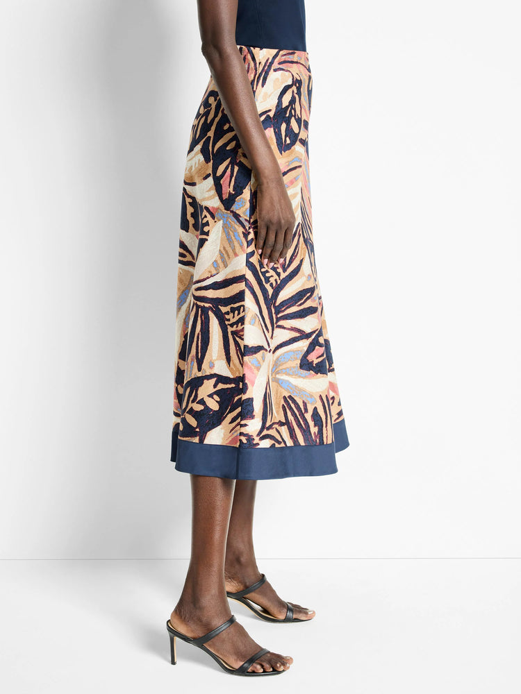 Terracotta midi skirt with navy blue, beige, and pink abstract leaf print. Navy blue hem.
