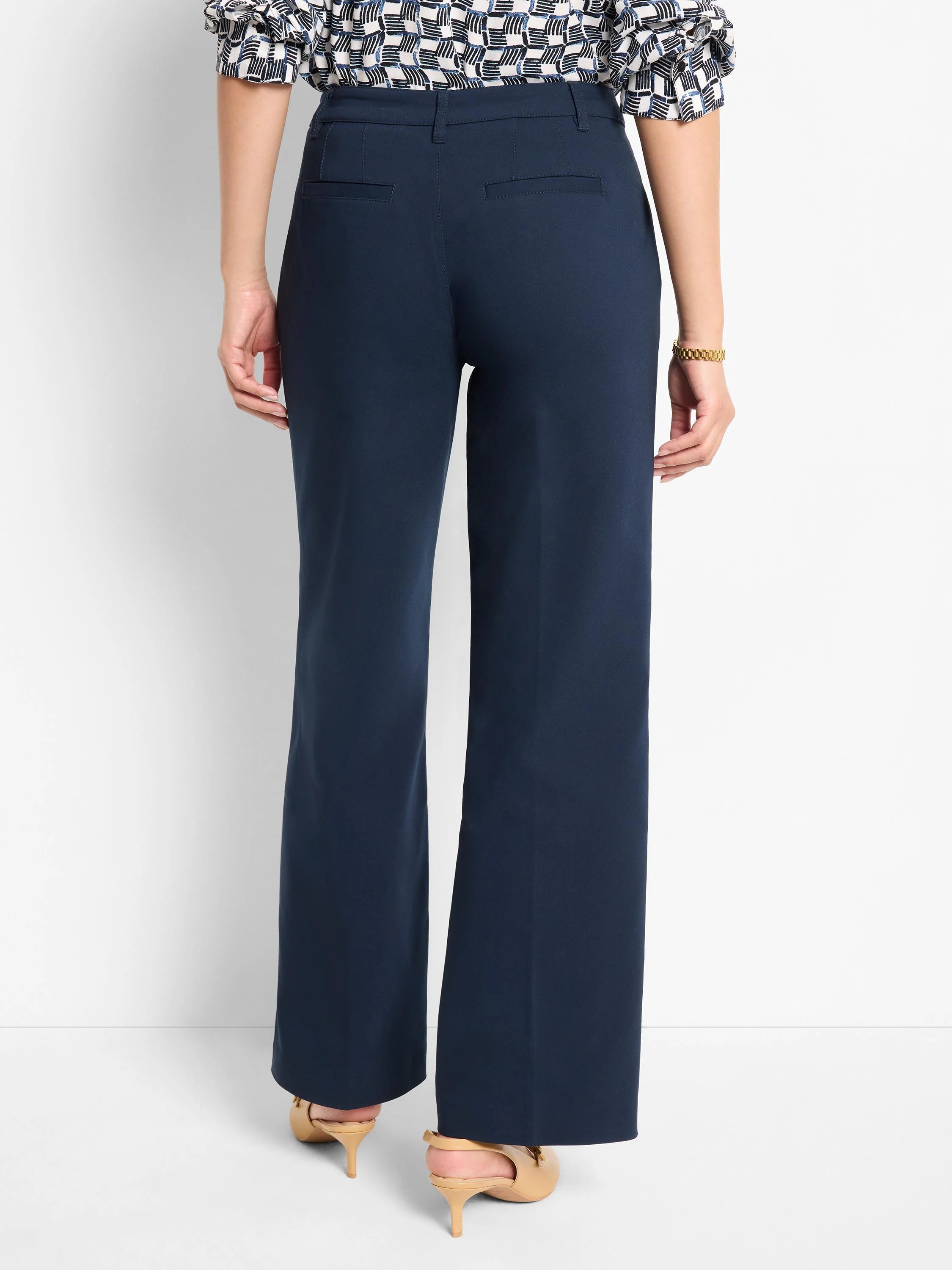 Dark navy blue, wide-leg, high-waisted trousers; back view.