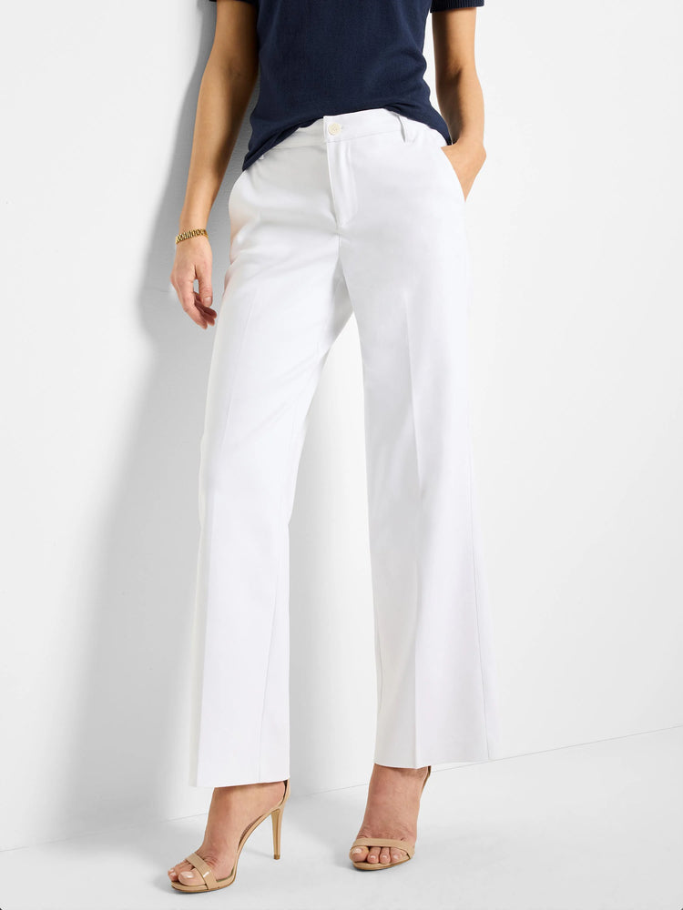 White wide-leg trousers; front view. Model wears nude heels.