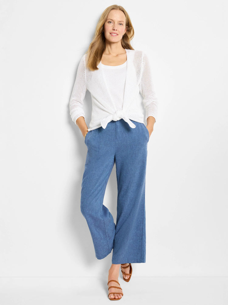 Blue linen wide-leg pants; mid-calf length. Model wears them with a white cardigan.