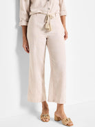 Beige linen pants with a beige rope belt and tassels.  Wide leg, cropped.