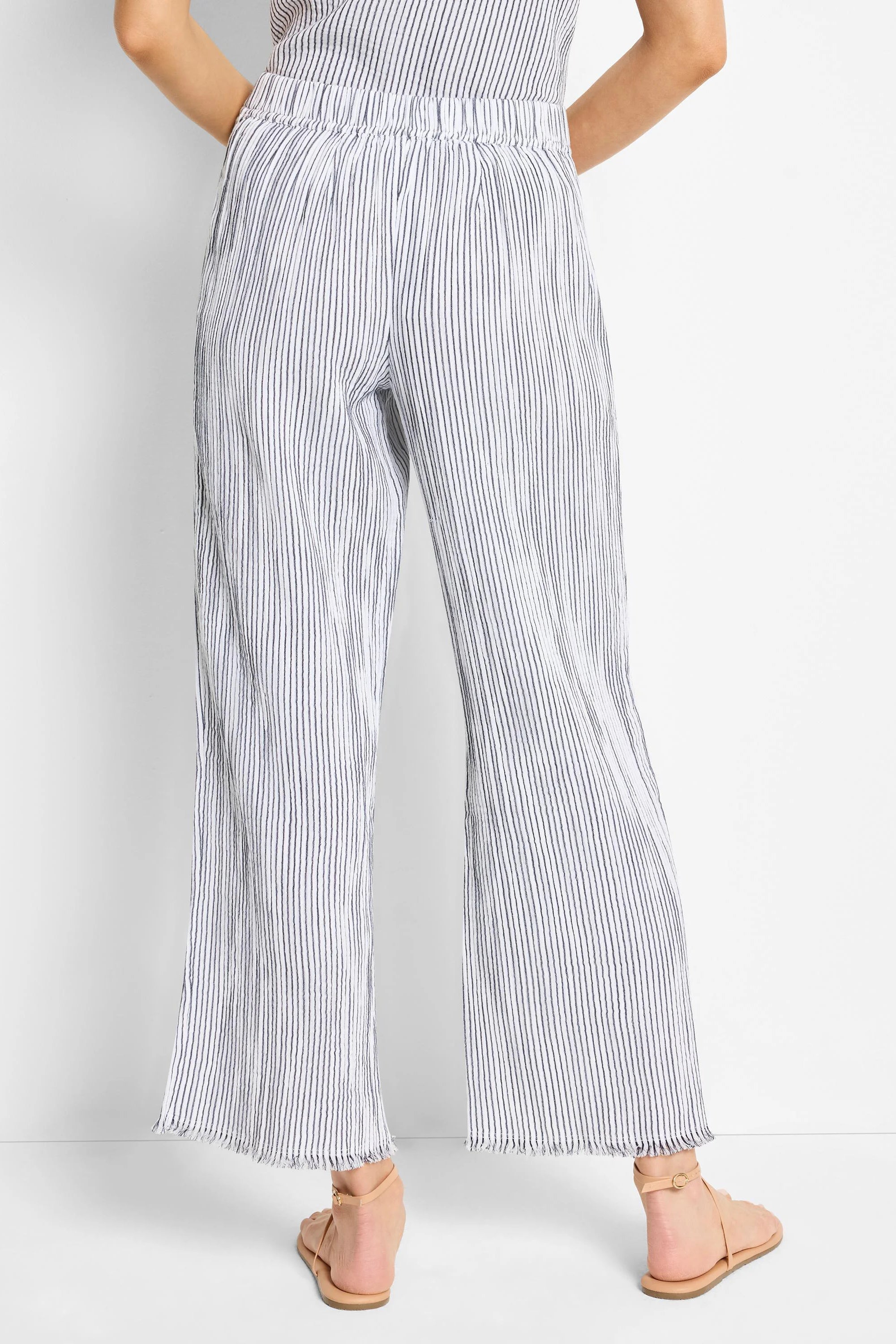 Here's alt text for the image, under 125 characters:
"Wide-leg pants; white with thin, dark blue pinstripes; elastic...