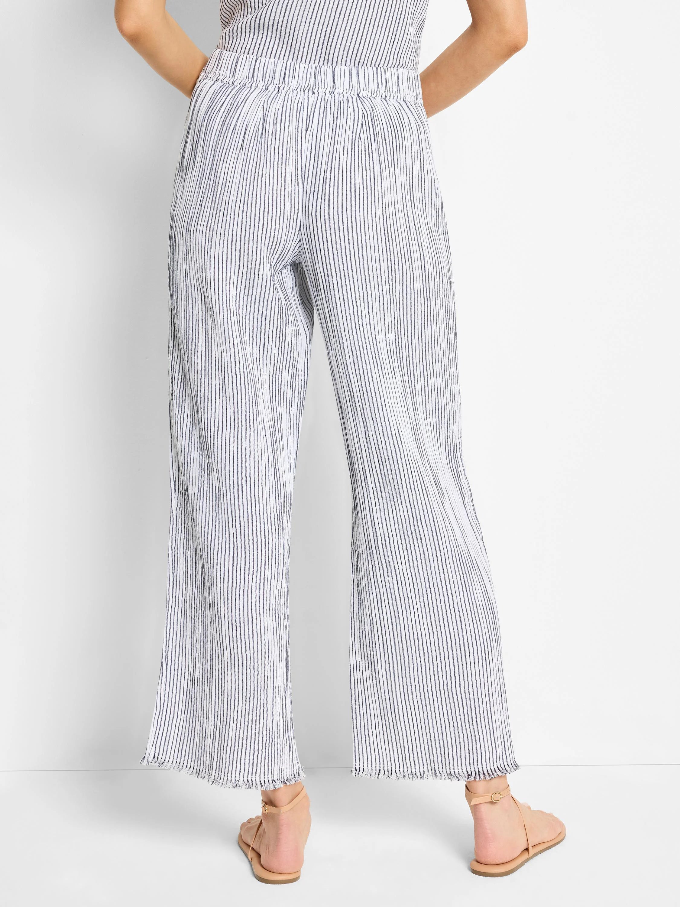 Here's alt text for the image, under 125 characters:
"Wide-leg pants; white with thin, dark blue pinstripes; elastic...