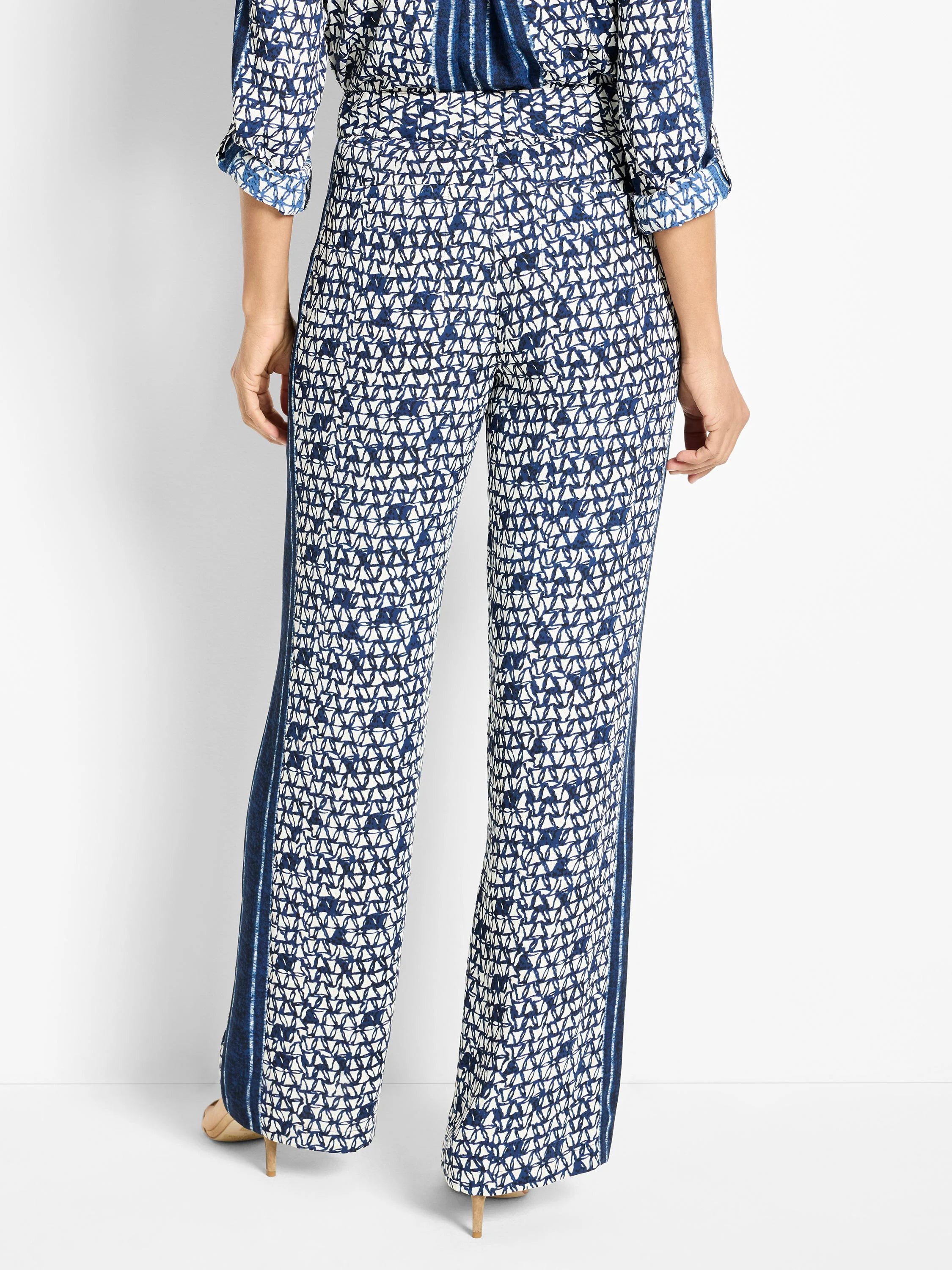 Wide-leg pants; navy blue and white geometric print, with vertical stripes along the sides.