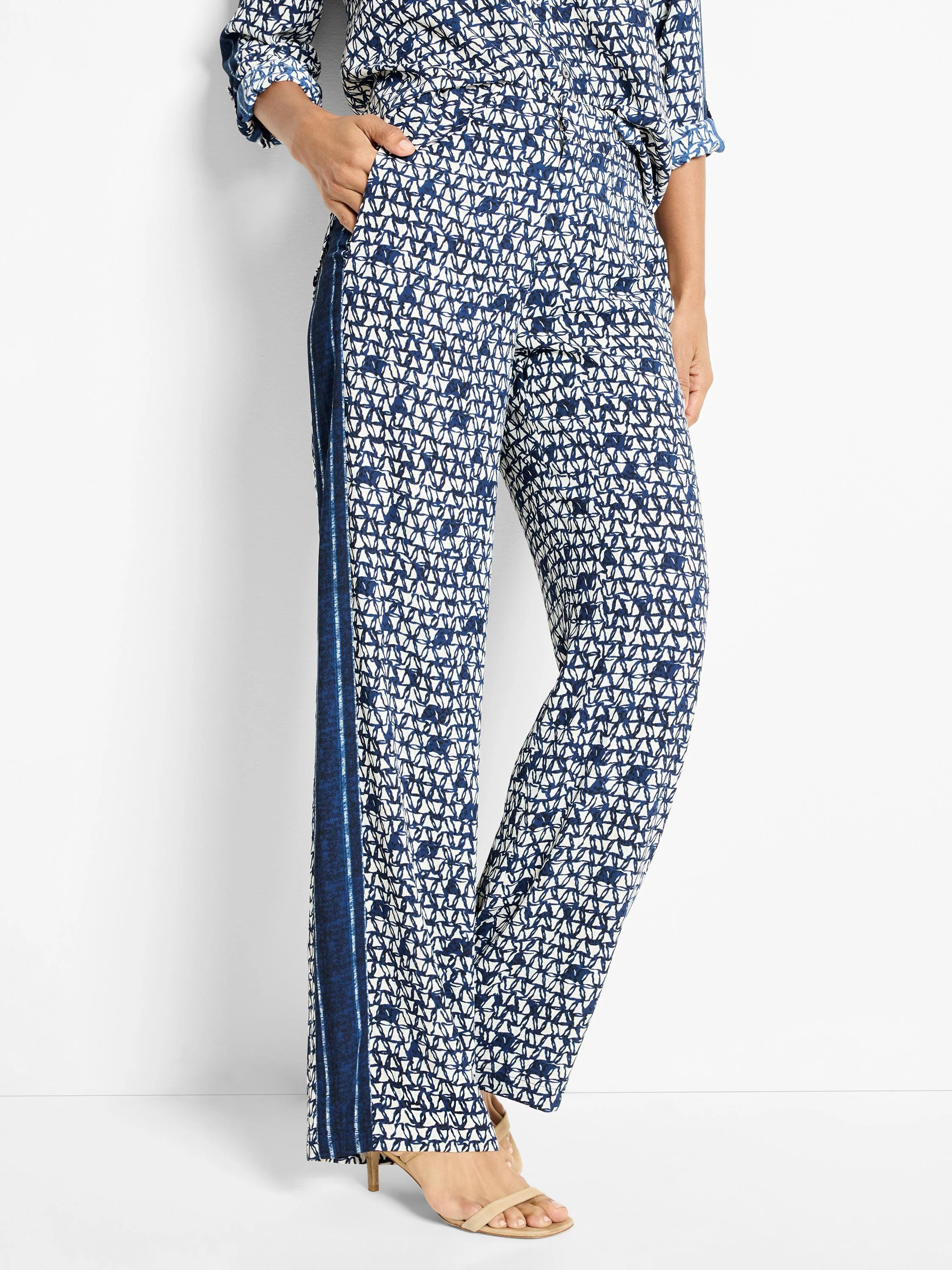 Wide-leg pants in navy blue and white geometric print.  Side panel in darker blue.