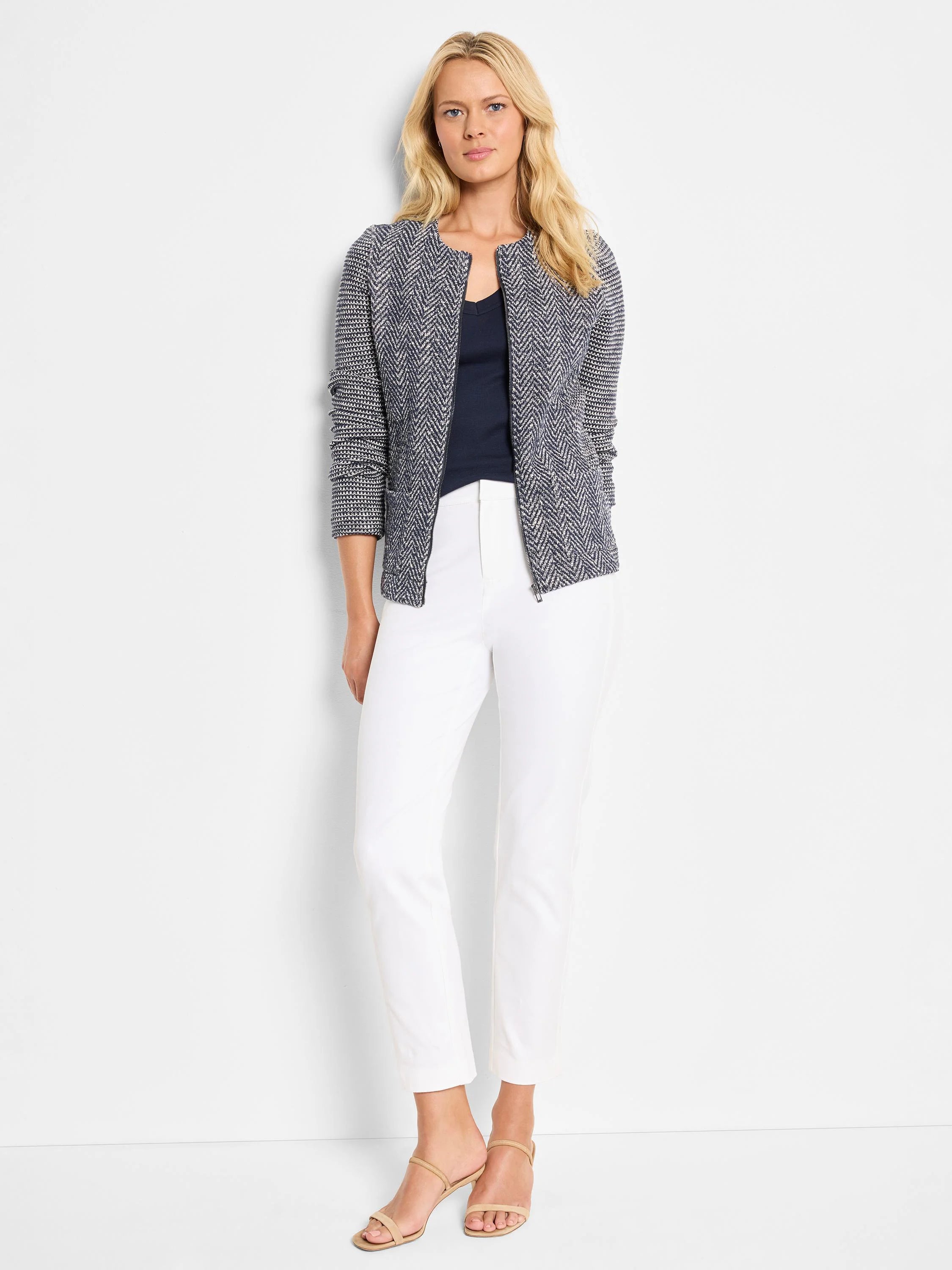 White straight-leg pants; model wears them with a dark patterned jacket.