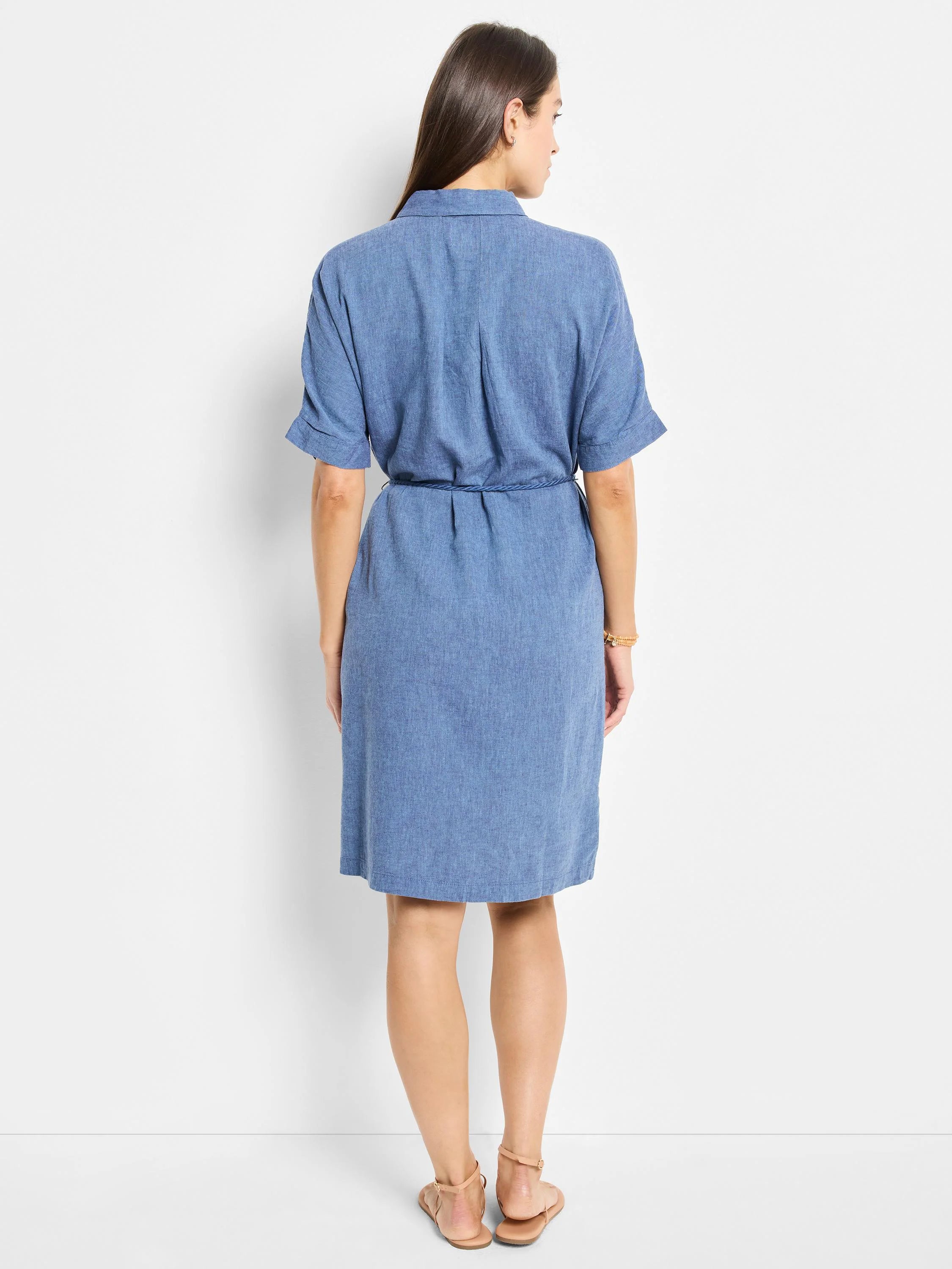 Blue linen belted shirt dress, short sleeves, knee-length.  Back view.